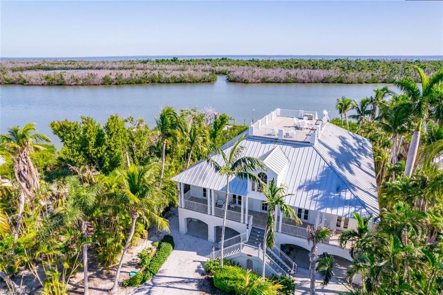 Located along the Tween Waters Stretch on Captiva Island is this fantastic upscale - classic island style retreat that sits on 1+ acre of land along the bayside. Built by Benchmark Construction and designed by well known Bud Lawrence, the property features a deep water dock for your boat and a deeded beach access just steps away. Tucked away down a long tropical drive way is the perfect island home for you to enjoy. The property is estate zoned which allows 3 structures. There is plenty of room for a guest house and pool if you desire. The home features outstanding quality. A spacious great room design that offers 4 private suites and a separete den. Beautiful wood floors, great mill work, beautiful kitchen w/ Viking appliances, elevator, are just some of the highlights you will enjoy. The lanai space is very enjoyable. One of the main features is the roof top sundeck w/ beach and bay views. Amazing Property! This is a great value and lifestyle. Dont miss this one!