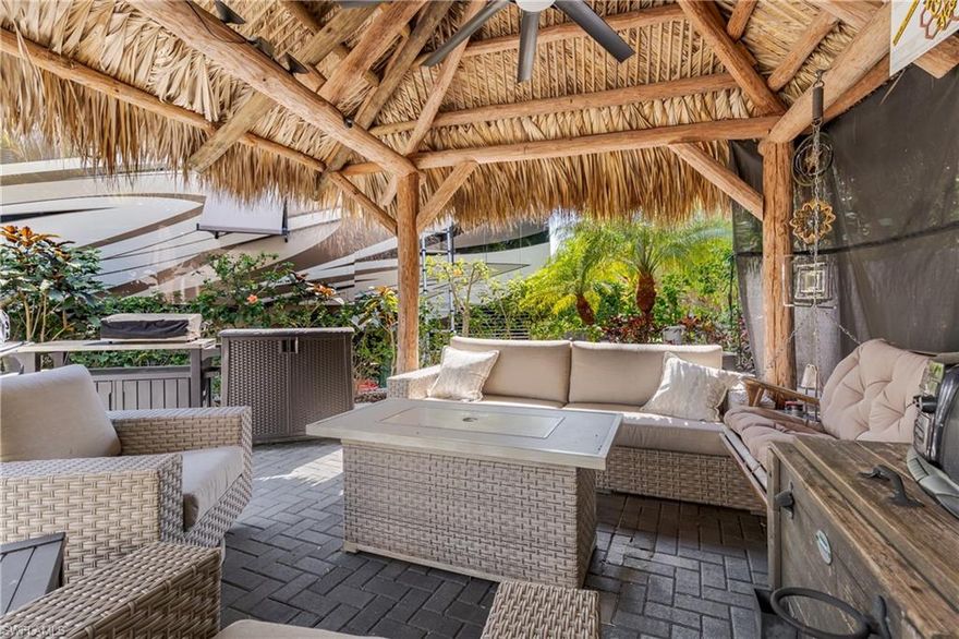 Lot 83 - Step through the gates of Naples Motorcoach Resort and be instantly transported to a tropical paradise, welcomed by manicured gardens, Royal Palm lined avenues, and elegant fountains leading to the grand clubhouse. Continue along picturesque, palm framed streets to arrive at your beautifully partially paved lot, enhanced by formal tropical landscaping and exceptional privacy. The property features a stunning tiki retreat perfect for relaxing or entertaining while enjoying tranquil breezes and illuminated palms at dusk. A privacy hedge creates a serene backyard oasis, ideal for outdoor dining, lounging, and future enhancements such as an additional water feature. 

Naples Motorcoach Resort is a premier Class A only community offering outstanding amenities, including an infinity pool, spa, fitness center, men’s and women’s saunas, catering kitchen, three pickleball courts, two additional satellite pools with spas, laundry facilities, and a dedicated dog park. Boating and nature enthusiasts will appreciate indirect Gulf access via the community boat ramp with kayaks available, providing easy access to Rookery Bay, nearby beaches, and waterfront dining. Investors take note: this deeded lot is mortgage-eligible and may be placed into the professionally managed rental program, making it an excellent opportunity for income or a 1031 exchange. Welcome to the lifestyle and magic of Naples Motorcoach Resort.