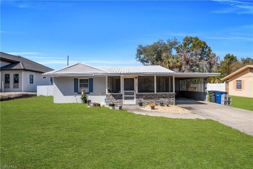 Opportunity awaits in this 2-bedroom, 1-bath home offering 1,171 sq ft of living space on a spacious 0.37 acre lot in North Fort Myers. Built in 1958, this property features tile fooring throughout, granite kitchen countertops, white shaker cabinets, a walk-in pantry, and a built-in workstation/desk area in the kitchen.

The kitchen opens to the living room with an adjoining  dining space, creating a functional and connected layout. From the dining area, access leads to the enclosed Florida room and a separate laundry area, providing additional flexible space. The bathroom features clean tile finishes and a glass shower enclosure.

Major improvements include a metal roof (2022) and updated septic drain field (leach field). The fully fenced yard (2020) includes a double gate with ample space for RV's, boats, trailers, or work vehicles. A detached rear structure of approximately 450+ sq ft offers excellent potential for a workshop, storage, hobby space, or future possibilities.

A covered front sitting area and covered carport provides additional access into the home near the laundry and dining areas. The expansive outdooor space makes this property ideal for those needing room for equipment, recreational vehicles, or expansion.

Conveniently located between US-41 and Downtown North Fort Myers with quick access to shopping, dining and daily conveniences.

Property is being sold AS-IS and offers great potential for investors, renovators, or buyers looking to customize and build equity.