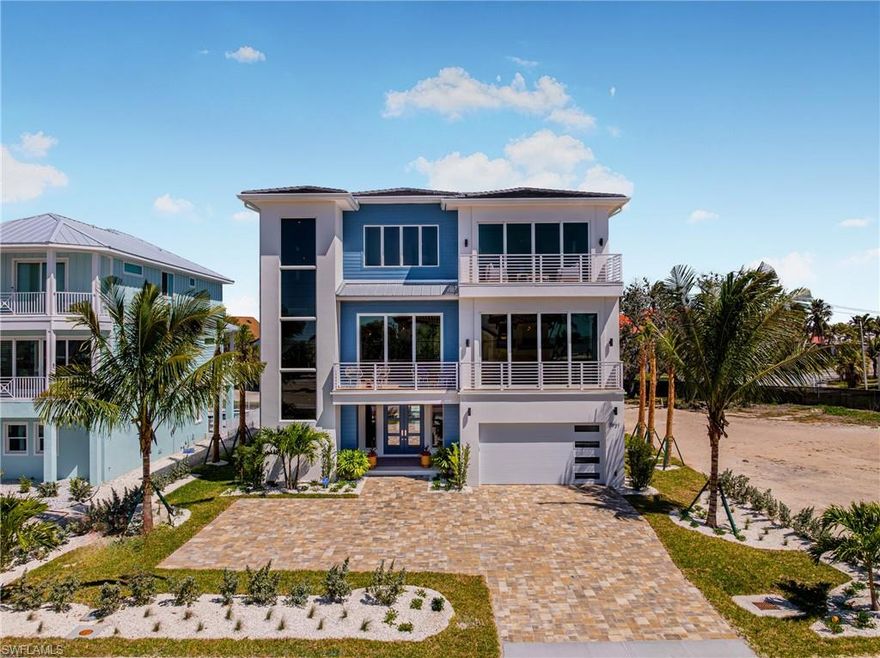 Overlooking the pristine sands of Fort Myers Beach, this BRAND NEW custom-built 3 story home by Imperial Homes offers the perfect blend of contemporary architecture and classic coastal charm. Designed as the ultimate luxury retreat, this 4,392 sq. ft. residence features 4 bedrooms and 4.5 bathrooms, with every detail thoughtfully curated to maximize panoramic Island/Gulf views, comfort, and elegance. Offered FULLY FURNISHED with design by Clive Daniel Home’s Sherie Weidner, the interiors reflect a modern take on “coastal vacation,” incorporating light natural woods, glass, and stone to create a truly unique and sophisticated atmosphere. From the moment you step inside, the open-concept layout captivates with high-end finishes, vaulted ceilings, and seamless indoor-outdoor integration. Floor-to-ceiling windows and multiple balconies frame breathtaking Gulf vistas, while the state-of-the-art chef’s kitchen, complete with top-tier appliances, a spacious island, and custom cabinetry, is ideal for both entertaining and everyday living. The luxurious primary suite serves as a private sanctuary, featuring a spa-like bathroom, walk-in closets, and a serene balcony. A separate game room, a striking rock wall fireplace, and a stylish martini lounge add to the home’s standout design. Outdoor living is elevated with a covered lanai, resort-style pool with spa, and beach access across the street, creating the ultimate setting for relaxation. Smart home technology allows for effortless control of lighting, climate, and security, ensuring modern convenience. Hurricane-resistant construction, impact-resistant windows, reinforced structural elements, and elevated foundations, this home is designed to withstand Florida’s weather. Energy-efficient features, including high-efficiency HVAC systems and smart irrigation, enhance sustainability without compromising luxury. This stunning home is a rare opportunity to own a piece of paradise on Fort Myers Beach in one of the best residential locations on the island! Ask about $300,000 Leaseback offered by builder!
