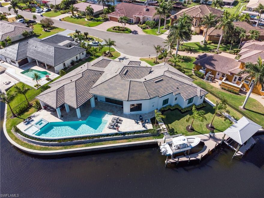 Town & River Waterfront Estate -luxury at it’s finest. This absolutely stunning 4400 sf, 4b/4ba(2 half baths) +den, home, built in 2020, boasts 230 feet of direct access waterfront on intersecting canals and located on a quiet cul-de-sac in one of the most desirable boating communities in SWFL. The interior features include a spacious open floorpan, soaring ceilings, hardwood flooring, and  superior custom details throughout. The luxurious main bedroom wing which includes an enormous custom closet, workout room, and gorgeous bath with his and hers water closets, freestanding tub and extra large shower. The gourmet kitchen offers only the best with Sub-Zero and Wolf appliances, gas cooking, waterfall edge island and a custom walk in pantry with a beverage station and built in coffee maker. All of the bedrooms feature private ensuite baths. Step outside and enjoy the panoramic water views and the Florida lifestyle with a fabulous resort style pool, outdoor kitchen, outdoor living room with gas fireplace, fire pit area, new dock and seawall (within the last 4 yrs) and 2 boat lifts (one covered)(16,000lb & 8,000 lb) There is nothing else like this on the market. See this now!