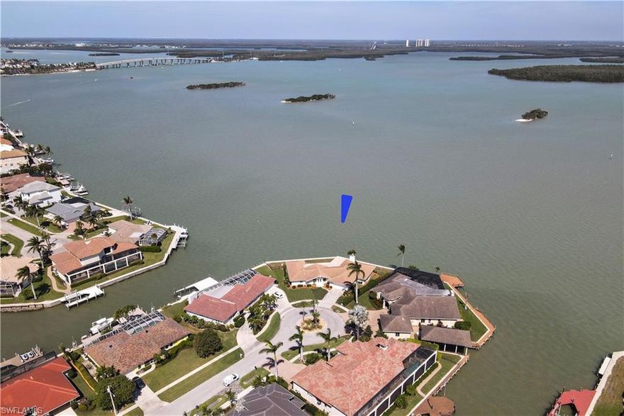 Incomparable Views! This strategically sited Tip Lot offers panoramic views of Big Marco River, Sanctuary Sound Charity Island & the iconic S.S. Jolley bridge. An idyllic setting, it offers endless entertainment of wildlife antics & sparkling "City Lights" at night. This charming Contemporary single story residence features endless views from virtually every room. Be dazzled as you enter the property and are transfixed by the incredible vista. Recent improvements include a new Sea Wall in 2016 and a new roof in 2019. Live comfortably in this inviting residence enjoying the 4 bedroom 2 1/2 bath floor plan or let your imagination run wild as you design the "Ultimate Dream Home". This is without question, Marco Island's Sui Generis" property. Drone video is a must see.