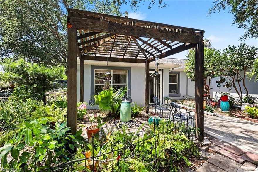 Nestled among towering oaks and graceful palm trees, this charming 2-bedroom, plus den, 2-bath home in Palmlee Park offers a peaceful retreat from the everyday hustle. Built in 1997, this home is more than just a place to live; it's a sanctuary where memories are made.  Imagine waking up in your bright, open-floor-plan home, with the sun spilling through windows and filling the space with warmth. The Florida room, bathed in light, invites you to enjoy tranquil views of your own private garden oasis. Mature trees sway gently in the breeze, and native plantings create an eco-friendly haven that blends seamlessly with the sparkling pool and inviting patio.  The home's layout has been designed with both comfort and convenience in mind. The split floor plan ensures privacy, while the spacious living areas are perfect for gatherings or quiet nights at home. And when you step outside, you'll find the perfect place to unwind. A spacious, fenced yard with meandering paths that lead to lush gardens, offering a quiet escape just steps from your back door.  Whether it's weekends spent lounging by the pool or hosting friends and family in your backyard paradise, this home was made for enjoying life's simple pleasures. The two-car garage and a separate garden shed ensure that storage is never an issue, so you can fill your space with all the things that matter most.  Located just minutes from the beautifully renovated Ft. Myers Country Club and the vibrant Downtown River District, this quiet, friendly neighborhood offers the perfect balance of serenity and accessibility. Whether you're strolling through the streets lined with trees or exploring the nearby cultural hubs, there's always something to love about living here.