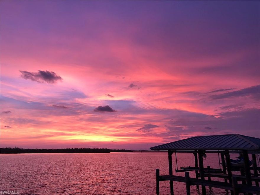 OWN THE VIEW! Once-In-A-Lifetime-opportunity to own the BEST LOCATION on ISLES OF CAPRI!  SUNSET VIEWS year-round! Nature's artistry with Monet-esque skies & wildlife can be yours! PREMIER POINT LOT w/ PANORAMIC 270-degree views of Johnson Bay, Rookery Bay Estuary & Gulf of Mexico. The lot boasts Western and Southwestern exposure with 245+ Ft  VESSEL-PROTECTED WATER FRONTAGE for your YACHTS.  GRANDFATHERED BOATHOUSE, multiple lifts, massive 5-ft wide seawall, 50-AMP Service connections, IPE walkways, & environmental RIP-RAP revetment BOULDERS.  Located in the idyllic community of ISLES OF CAPRI surrounded by a STATE-AQUATIC PRESERVE, “ROOKERY BAY” w/ pristine blue-green water clarity & abundant wildlife every day.  Daily sightings of Dolphin pods, Blue Herons, Osprey, Pelicans, Manatee, Ibis, Curlews, Doves & Woodpeckers visit this premier lot every day. Catch your BAIT and Fisherman's SUPER GRAND SLAM right from the docks! A previous neighbor who visited us several weeks ago caught 36 redfish from the house without even using an ounce of gas to propel a fishing vessel.  Three young children had a blast. Property is being sold AS IS for the LOT VALUE. The driveway can hold 10 cars and 2 vehicles inside the 2-car garage. Garage Door is impact-rated.  RARE OPPORTUNITY to BUILD YOUR DREAM HOME on this AMAZING TIP LOT. NIGHT CONSTELLATIONS visible every night & sightings of SEAPLANES and HINCKLEY YACHTS dining locally. This property has one of the most expensive standing-seam galvanized metal roofs one can buy that can last 30-50 years.  County Appraiser states effective year of house is 1995, however, it was totally brought up to code back in 2003 when the builder added a second-floor addition with two large bedrooms upstairs with high ceilings, a walk-out balcony, and tons of closet space. Everything was brought up to code. Nassau Pools built a new swimming pool & waterfall in 2003 with seashell deck tiles and a white screened-cage, Please note that during Hurricane Wilma, when ?everyone" on the island lost their pool cages, this cage remained standing strong and was printed up in the newspaper as surviving head-on wind. Brazilian Ipe-wood used on outdoor patio on the NW-side primary suite, ipe-wood added to Captain's Walk on South side & steps up to pool, ipe added to the Boat House decking, and we currently have stored ipe wood for future owner to continue the boardwalk that sat over the 5-foot wide concrete walkway. There is a 3rd primary ensuite on 2nd floor w/ French Doors that lead out to balcony overlooking Rookery Bay, mangroves, and views of the Gulf of Mexico and majestic sunsets. Future owner will have the option to make the fourth bedroom into a TV/movie theatre room.  Be sure to visit Rookery Bay during the day and explore the local protected environment that surrounds Isles of Capri. This OVERSIZED BAYFRONT MAGICAL LOT on the GULF SIDE of Capri has NOT been transferred in OVER 23 years. In fishing terms, "It's A KEEPER!"   Owner/Agent