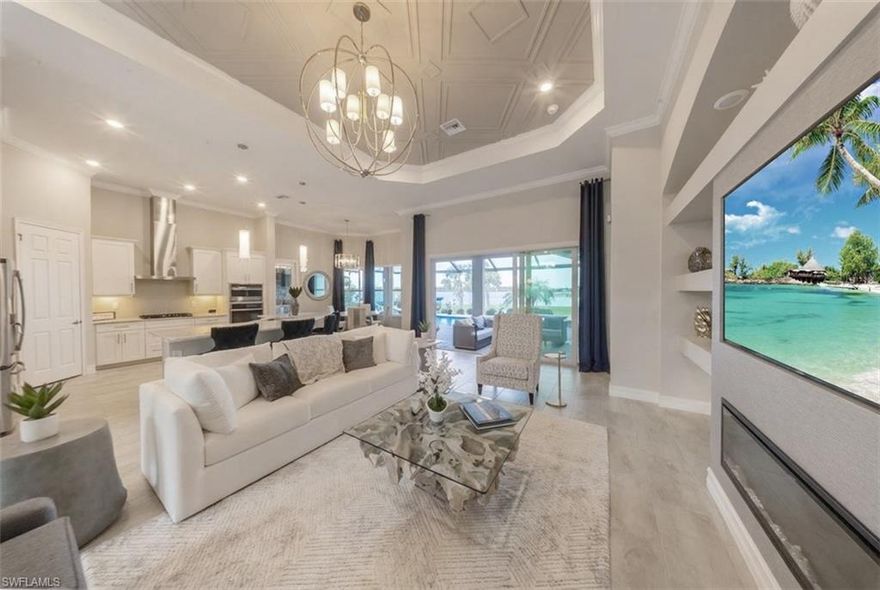 EASTERN EXPOSURE, beautiful sunrises on an OVERSIZED LAKEFRONT and TURNKEY FURNISHED, this like-new 4 bedroom, 3 bath RENTAL offers a light, coastal-modern feel with a thoughtfully designed layout and refined finishes throughout. The popular floor plan creates an open, inviting atmosphere delivering a true Southwest Florida lifestyle with direct access to one of WildBlue’s rare RECREATIONAL LAKES.  Boating, kayaking, paddle boarding, jet skiing, and fishing can be enjoyed directly from your backyard. Outdoor living takes center stage with an EXPANSIVE LANAI designed for both relaxation and entertaining. The HEATED POOL AND SPA overlook sweeping wide-water views, creating a tranquil setting for morning sunrises and evening gatherings. A STONE GAS FIREPLACE WITH MOUNTED TV anchors the space, while the SUMMER KITCHEN WITH GRILL AND PREP AREA provides everything needed for seamless outdoor dining. Enhanced exterior lighting, NEW LANAI FANS, PROFESSIONALLY SEALED PAVERS, and UPGRADED LANDSCAPING further elevate the experience. The main living area features a clean, COASTAL AESTHETIC coastal aesthetic with IMPACT WINDOWS AND SLIDERS, 8-FOOT INTERIOR DOORS, and curated DESIGNER LIGHTING. The open-concept design flows effortlessly into the kitchen, where function meets style with ample workspace, SOFT-CLOSE CABINETRY,  and elevated finishes ideal for everyday living and entertaining. The primary suite is positioned to capture peaceful LAKE VIEWS and offers direct LANAI ACCESS, creating a private retreat with a seamless indoor-outdoor connection. The en-suite bath is designed for comfort and convenience, while a guest bath with direct lanai access enhances functionality for poolside living. A flexible layout provides versatility with additional guest bedrooms ideal for hosting or creating a dedicated workspace, media room, or hobby area to fit a variety of lifestyles. Additional features include DUAL-ZONE AIR CONDITIONING, TANKLESS GAS WATER HEATER, ADT SECURITY SYSTEM, REMOTE-CONTROLLED PRIVACY BLINDS, and an AIR-CONDITIONED GARAGE with MINI-SPLIT SYSTEM, EPOXY FLOORS, ADDED INSULATION, UPGRADED ELECTRICAL, and WALL-MOUNTED TVS. A dedicated laundry area adds everyday convenience. Living in the WildBlue community you will enjoy access to a 20-ACRE AMENITY CAMPUS featuring a LAKEFRONT CLUBHOUSE RESTAURANT AND BAR, RESORT-STYLE POOL WITH CABANAS, OLYMPIC LAP POOL, STATE-OF-THE-ART FITNESS CENTER, PICKLEBALL, TENNIS, BASKETBALL, and BOCCE. Scenic WALKING AND BIKING PATHS, along with KAYAK AND BOAT LAUNCHES, complete the lifestyle. Ideally located near Bonita Beach, Naples, premier shopping, dining, and Southwest Florida International Airport, this residence offers a rare opportunity to enjoy luxury LAKEFRONT LIVING in one of the area’s most sought-after communities.