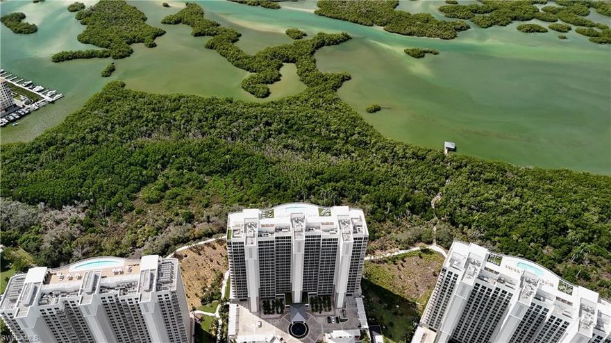 A RARE 02 PENTHOUSE WITH PRIVATE 3 CAR GARAGE IN KALEA BAY TOWER 200
Introducing an extraordinary opportunity to own the exclusive 02 Penthouse Residence in Kalea Bay Tower 200 — the first of its kind to be offered with a private 3 car garage. This four-bedroom, four-and-a-half-bath coastal masterpiece defines elevated living within one of Naples’ most prestigious waterfront addresses.
Soaring 10-foot ceilings and sweeping views of the Gulf of Mexico set the tone for an atmosphere of timeless sophistication. Floor-to-ceiling glass reveals uninterrupted, private vistas that stretch endlessly across the water — where each evening concludes with a sunset worthy of a postcard.
Inside, every detail has been meticulously curated for the discerning buyer. The expansive open-concept great room blends seamlessly with the outdoors, flowing onto a spacious lanai ideal for both intimate evenings and grand entertaining. A statement custom ceiling adds architectural drama, while the ambiance throughout is one of effortless luxury.
At the heart of this residence lies a chef’s-caliber kitchen—a showcase of sleek, modern design and superior functionality. Outfitted with Wolf and Sub-Zero appliances, quartz countertops, custom cabinetry, a natural gas cooktop, and a built-in wine cooler, it’s a dream for both the culinary enthusiast and the entertainer. The adjacent butler’s pantry—with an additional dishwasher and prep sink—enhances the ease of hosting.
The Owners suite offers a serene retreat with sweeping Gulf views and an indulgent spa-inspired bath featuring a deep soaking tub, glass-enclosed shower, and dual designer vanities. Three additional ensuite bedrooms capture stunning vistas of the golf course and The Club at Kalea Bay, offering both comfort and privacy for family and guests.
Completing this exceptional offering is the largest private garage in Kalea Bay—an oversized, secure space accommodating two vehicles, a golf cart, and abundant storage. A truly coveted amenity in high-rise living.
Ownership at Kalea Bay means access to a lifestyle without compromise: three shimmering pools, two restaurants, two lively pool bars, and a 14,000-square-foot wellness sanctuary featuring state-of-the-art fitness, spa, and racquet facilities—all within a gated, resort-style waterfront enclave.