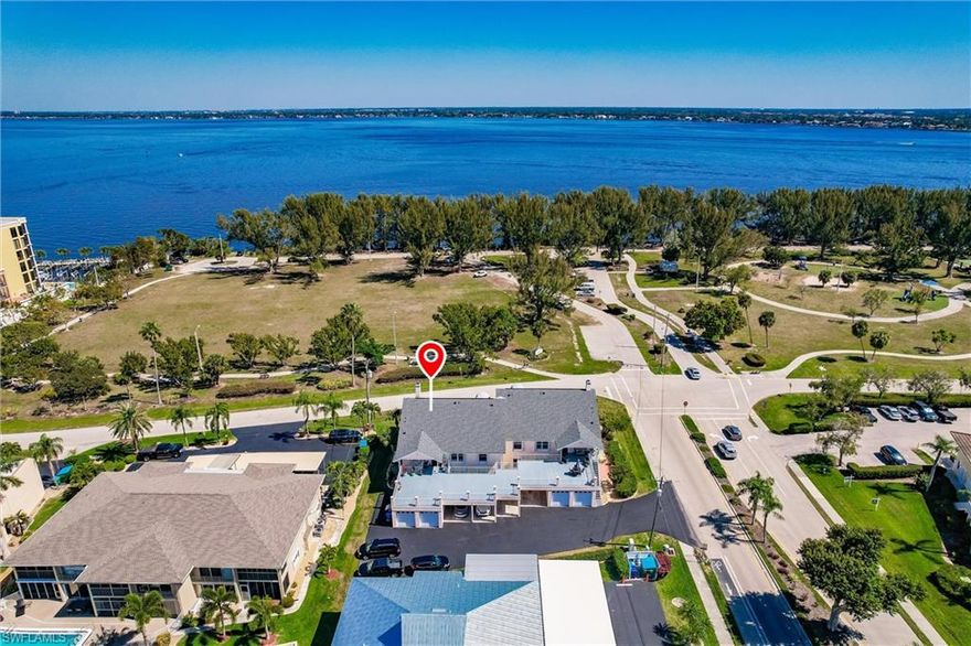 MOTIVATED SELLERS - Moving out of state. Bright, open & beautifully updated! This welcoming 55+ Cape Coral condo is only a stone's throw from Jaycee Park and features eye-catching views of the Caloosahatchee River! You can see it all from the large SCREENED lanai which offers great indoor/outdoor living. This 2BR+DEN/2BA is spread across nearly 2,000sqft w/ a flex space for use as an office or third bedroom. As you enter, you immediately notice the gorgeous vaulted ceilings and completely renovated kitchen (2020) w/ample cabinets for plenty of storage, LG stainless steel appliances (w/ induction stove), gorgeous quartz countertops and mini fridge for storing more drinks and wine. Updates extend into both the guest and primary bathrooms where you'll also find quartz countertops and updated cabinets and tiling. Escape into your primary bathroom equipped with a large walk-in shower w/ modern floor and wall tiling, sinks, faucets and light fixtures. Peace of mind comes standard with this unit as other updates include roof (2023), tankless water heater (2020), A/C unit including duct work (2019), electrical (2021), windows (2019) and newer front load washer & dryer. The unit is offered with a covered parking spot and a separate garage unit with keypad access. Location can't be beat as you are near both bridges into Fort Myers & major highways, restaurants, shopping or relaxing at Jaycee Park. Don't wait to schedule your showing, come see it today! Only 1 owner must meet 55yo minimum.