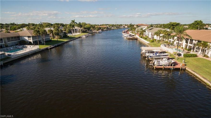Does it get any better than a gorgeous, end unit, waterfront condo to escape to in Florida?! Updated condo on the 200ft  Rubicon canal. Enjoy pool by day and sunsets in the evening with the Western view. Features include new laminate and tile flooring, new interior paint, new kitchen, and bathrooms upgraded. The kitchen has new Stainless Appliances, granite counters, and soft close kitchen cabinets. Both bathrooms are upgraded including the tile floors, cabinets, and matching granite tops. If boating is your passion you can add a dock and lift. Deeded dock space is still available at this time and would need to be installed, and then your toy is out your back door! This condo is located near Downtown shopping, restaurants, and the Cape Coral Yacht-Club and fishing pier. Don't miss out on your piece of paradise!