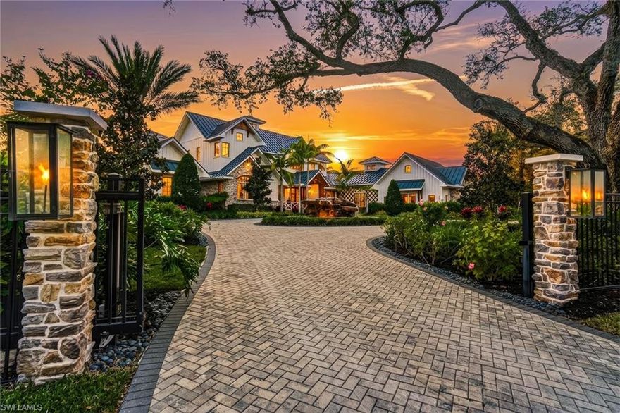 This is a one-of-a-kind Naples riverfront estate set on 3.29 gated acres along the Cocohatchee River with direct Gulf access. Built in 2021, this exceptional property combines expansive waterfront acreage with a nationally recognized, resort-style outdoor environment designed for unforgettable entertaining. The defining feature is the extraordinary Lucas Lagoons backyard, created by Lucas Congdon of Insane Pools. Natural stone anchors a multi-level saltwater pool with spa, waterfalls, fire bowls and waterslide. A propane fire pit, integrated sound system and layered landscape lighting complete the immersive setting, designed to accommodate intimate evenings and large-scale gatherings. Covered outdoor living areas with wood ceilings and a gas stone fireplace connect seamlessly to a fully equipped outdoor kitchen featuring an alfresco grill, hibachi station, leathered quartzite countertops, ice machine and ample prep space. A private putting green and multiple seating areas reinforce the estate’s self-contained resort layout along the river. Inside, white oak flooring, exposed beams, and brick detailing create architectural warmth and character. The chef’s kitchen is appointed with a La Cornue gas range, dual Sub-Zero refrigeration, quartzite countertops, custom cabinetry, and high-end appliances designed for performance and style. A detached guest house provides additional privacy and flexibility, while expansive garage capacity accommodates up to 10 vehicles with lift capability, ideal for collectors and enthusiasts. Along the riverfront, a private illuminated dock with two boat lifts and two Jet Ski lifts, including a covered slip, offers direct access to the Gulf. In a market where waterfront acreage is increasingly rare, 325 Cocohatchee Boulevard presents the opportunity to own a fully completed, gated estate anchored by one of Southwest Florida’s elaborate residential outdoor environments.