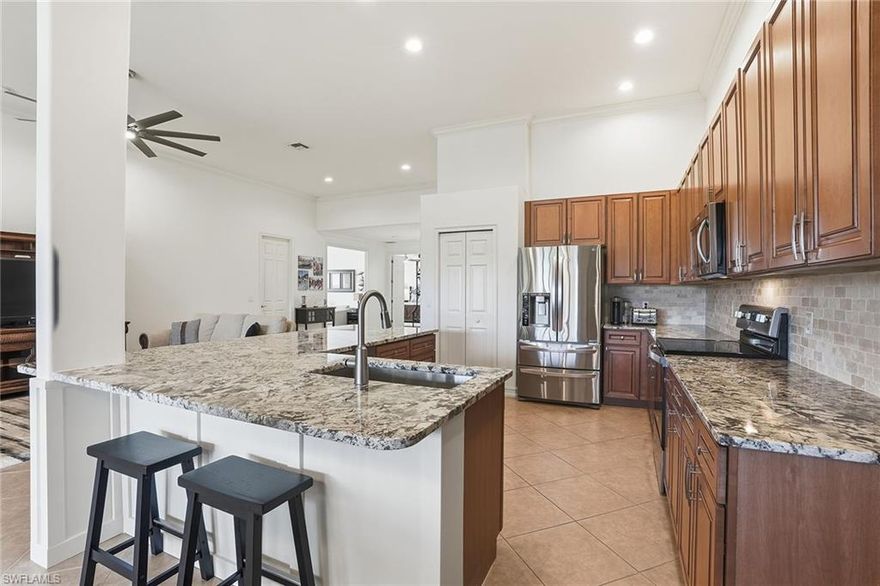 This beautifully reimagined residence blends timeless luxury with modern sophistication and commands breathtaking golf course views, refined architectural upgrades and delivers an elevated Southwest Florida lifestyle with panoramic scenery. Spanning a thoughtfully designed 3-bedroom plus den, 3-bathroom layout with a 2-car garage, the home features two expansive primary suites, each complete with its own ensuite bath—ideal for multigenerational living or hosting guests in complete comfort. A fully renovated kitchen serves as the heart of the home, where the removal of a dividing wall has transformed the space into a bright, open-concept showpiece. Crisp cabinetry, sleek countertops, and seamless flow into the living and dining areas create an entertainer’s dream framed by soaring ceilings and abundant natural light. Throughout the residence, tile and luxury vinyl flooring provide a clean, cohesive aesthetic, while the lanai is enhanced with electric hurricane shutters, allowing effortless indoor-outdoor living year-round. Generous storage solutions are thoughtfully integrated throughout the home, adding both function and ease. Step outside to enjoy tranquil golf course views paired with a cool northeast rear exposure, delivering refreshing breezes and golden morning light—perfect for coffee at sunrise or unwinding after a day on the course. Every detail has been curated to offer comfort, elegance, and effortless Florida living. Renaissance lifestyle offers an Arthur Hills championship golf course with memberships available immediately, a lavish resort-style pool and pavilion, a children's play area, a full-service spa and fitness center, six red clay tennis courts, two pickleball courts and two bocce courts.