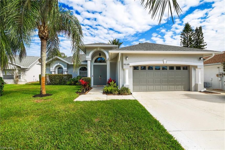 Offered furnished, this lakefront residence is ideally positioned at the end of a quiet cul-de-sac, capturing long water views and added privacy with only one neighboring side. The setting creates a peaceful backdrop, enhanced by mature tropical landscaping and a wide lake frontage. Designed for indoor-outdoor living, the home features multiple sliding glass doors that open to a screened lanai with a heated pool and spa perfect for everyday enjoyment or entertaining. The outdoor space offers both covered and open areas to relax while taking in the water views. Inside, a functional three-bedroom split floor plan provides comfortable separation of space. Volume ceilings and abundant natural light enhance the main living areas, complemented by neutral tile flooring and luxury vinyl in the bedrooms. The kitchen includes white cabinetry, new quartz countertops, a pantry, and a casual dining area.
The primary suite is generously sized with multiple windows overlooking the lake, and includes a bathroom with dual sinks, a soaking tub, and a separate shower. Recent improvements include a 2022 roof, new pool cage, updated air conditioning system, water heater, impact-rated lanai slider, fresh exterior paint, and epoxy garage floor. Located in Queens Park, this property offers convenient access to downtown Naples, including shopping, dining, beaches, and local parks. Low annual HOA fees.