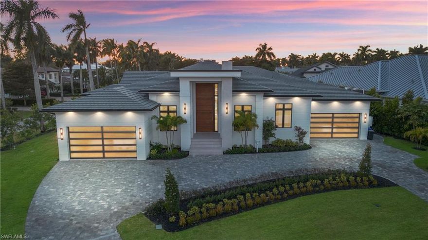 Designed by JMDG Architecture, this brand new Moorings residence reflects over 45 years of international building experience, with the builder spending a full month in Italy working directly with Idea Group to model the home after true Italian modern residences with seamless flow and intentional simplicity. Porcelanosa finishes are used throughout the home, including all interior flooring, all bathrooms, exterior flooring, and the outdoor kitchen, creating a consistent and intentional design throughout. There are no baseboards, no crown molding, no door frames, and no traditional door hardware, with every interior door designed as a custom pivot door built directly into the walls using integrated hand-slit pulls. The kitchen is outfitted with full Gaggenau appliances, including two full ovens plus a steam oven, dual dishwashers, a temperature-controlled wine cooler with approximately 240-bottle capacity, onyx countertops, and a flush cooktop with a built-in pop-up downdraft ventilation system that rises during use and disappears when not in use. Additional features include a Pentair whole-home water filtration system, a 1,000 gallon propane tank, impact windows and doors, and expansive indoor-outdoor living with a custom pool, spa, and outdoor kitchen, all thoughtfully designed with no wasted space and no unnecessary detail.