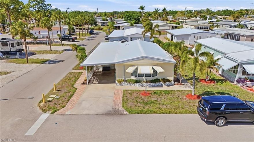 Welcome to the highly sought-after co-op community of Imperial Bonita Estates, where vibrant 55+ living meets true neighborhood charm. From the moment you enter, you’ll feel the warmth of this active community, neighbors out enjoying the day, friendly waves as you pass by, and a lifestyle that’s both social and inviting.

Perfectly positioned on a corner lot and just moments from the community amenities, this home offers both convenience and a prime location within the neighborhood. As you arrive, the covered carport and enclosed Florida Room welcome you in an ideal space to relax, unwind, or greet guests before stepping inside.

The interior opens to a bright and airy great room, dining area, and kitchen, creating a seamless open-concept layout that’s perfect for entertaining. Whether hosting friends or enjoying quiet evenings at home, this space is designed for easy, comfortable living.

Both bedrooms are generously sized with ample storage, offering flexibility for guests, hobbies, or simply spreading out. The home also features a large storage area with in-residence laundry, adding to the practicality and ease of everyday living.

Step outside and you’ll find one of the true highlights of the home is a beautifully pavered patio with a charming tiki hut, creating your own private outdoor retreat. It’s the perfect setting for afternoon gatherings, evening cocktails, or simply enjoying the Florida lifestyle year-round.

This community truly elevates the experience with a brand-new resort-style pool, kayak launch/boat ramp, shuffleboard courts, and a clubhouse filled with amenities and social activities, offering endless opportunities to stay active and connected.

Ideally located just minutes from Bonita Springs’ white sandy beaches and a short drive to Southwest Florida International Airport, you’ll enjoy both relaxation and convenience right at your fingertips.

If you’ve been searching for a home that combines location, lifestyle, and entertaining space, this one checks all the boxes.

Schedule your private showing today, this is one you won’t want to miss.