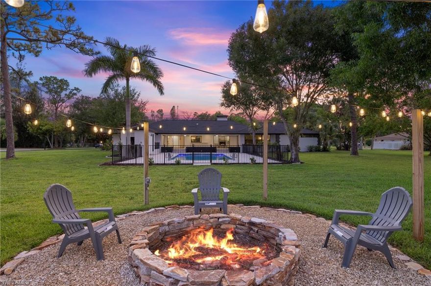 A rare opportunity to own an extensively renovated estate home on acreage in the heart of Ft Myers, located in Heritage Farms, one of the area’s most desirable hidden enclaves offering tranquil, oak-canopied country living just 15 minutes to Fort Myers Beach and 20 minutes to Sanibel Island. This year-long luxury transformation represents over $650,000 in no-expense-spared renovations, delivering more than 4,200 square feet of refined living space on 1.37 acres of mature trees, an increasingly rare combo this close to the beaches. Exterior upgrades include a New Owens Corning shingle roof, New 4-ton and 2.5-ton A/C systems, full plumbing re-pipe, New hurricane-impact windows and French doors, an 18-foot hurricane-rated garage door, dual water heaters, irrigation on well, and a state-of-the-art whole-home reverse osmosis water purification system. The resort-style outdoor living area features a new pebble-finish pool with color-changing LED lighting, new equipment, brick paver pool deck and lanai, black aluminum pool fencing, outdoor pool bath with shower, fire pit with Edison lighting, enhanced exterior lighting, and multiple tree swings. Inside, the home showcases wide-plank flooring throughout, 5 inch baseboards, extensive LED recessed lighting, custom wood feature walls, pine solid-wood interior doors with black hardware, bespoke accent lighting, a formal living room with a custom-built railing and integrated LED baseboard lighting, and a family room anchored by a certified brick wood-burning fireplace with smooth stucco finish and custom wood mantle. The kitchen is a true centerpiece with white shaker cabinetry including 42” uppers, multiple freestanding pantries, quartz countertops, an expansive oversized island with storage on both sides, GE stainless appliances including dual refrigerators, and subway tile backsplash extending around the kitchen window. The primary suite offers a private retreat with a custom wood focal wall and seating area, two walk-in closets, an expansive white shaker vanity with quartz counters and custom mirror, freestanding soaking tub, frameless glass shower, and a private screened garden area, while three additional guest baths feature large-format porcelain tile showers, white shaker vanities with quartz counters, and modern black mirrors. An in-law suite with kitchenette and private entrance provides exceptional flexibility, ideal for extended family, guest lodging, or a private home office, further enhanced by AG-2 zoning which allows for operating a business from the property subject to code. Additional highlights include custom LED-lit hallways, an oversized laundry room, epoxy-finished garage, and 4 sets of pocket sliders opening to the expansive lanai with wood-plank ceilings matching the front porch. Located in a top-tier school district with the new Nova Classical STEM Academy opening in 2026 just minutes away, this is a truly irreplaceable estate-style offering on acreage in a central Ft Myers location.