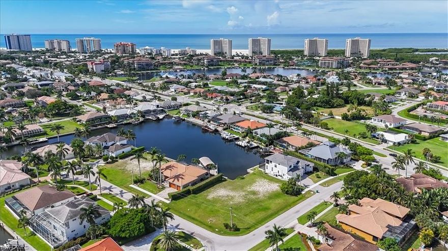 This uniquely shaped waterfront lot on Marco Island offers expansive dimensions, creating the ideal setting for a grand estate with a circular driveway and beautifully landscaped grounds. The property is mere minutes by boat from the open Gulf. Its southern rear exposure ensures abundant sunlight throughout the day, while the prime location puts pristine beaches within comfortable WALKING distance. Residents also enjoy proximity to the island’s premier shopping, dining, and entertainment, making everyday living vibrant and accessible. 
Here, tranquility and luxury converge, presenting a personal retreat as well as a gateway to Marco Island’s lively coastal lifestyle. The generous lot accommodates a substantial residence tailored to your preferences, with room for luxury amenities such as a pool, and amazing outdoor living spaces. Seize this exceptional opportunity to create a legacy home perfectly aligned with your vision, in a coveted community celebrated for its natural beauty, exclusivity, and the best that Florida waterfront living has to offer.