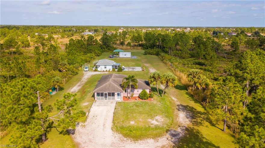 WITH A GUEST HOUSE WOW! Best opportunity in Golden Gate Estates come home to over 2 acres of land-Come and enjoy the NO HOA Living., Main house has Four bedrooms two bathrooms, NEW AC, New well pump Cleared land with plenty of room for a pool. and as if that wasn't enough Adorable guest house built  in 2014, with it's own septic, one bedroom one bathroom , stunning Kitchen with an island and dining area, Walk outside to your spacious screen lanai. As we continue outside you will also have a Medal building storage 12x 24 with concrete slab all permitted. want more?  another covered storage. A Concrete area ready for animals enclosure. Fenced on three sides of the house, Just minutes away from the Brand New Publix on Randall!