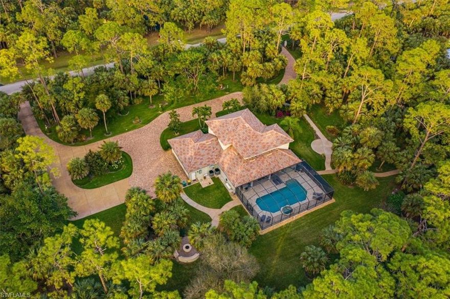 H8081- Enter through private gates to enchanting and beautifully manicured grounds gracing over 2.5 acres. Encompassing a gorgeous estate home in the heart of Logan Woods, this special property & home were custom-designed for easy living. Featuring solid Brazilian cherry wood flooring, a cheerful family room with soaring 20 ft ceilings plus custom windows & built-ins, this home surprises at every turn. The chef’s kitchen offers gas cooking, Bosch appl, wine cooler & wrap-around granite island. Informal & formal dining areas invite both inside & out and the separate den/office is tucked away for privacy. First floor master w sitting area & marble bath opens to the screened lanai & is a welcome retreat while the second floor boasts two en suite bedrooms & a third currently used as a common area/game room. The screened lanai features pool/spa, outdoor kitchen w quartz bar, refrigerator, gas grill and covered & uncovered seating areas. Plantation shutters, surround sound, hurricane rated doors & windows, reverse osmosis water system, built-in fire pit w benches, gracious landscape lighting, 3-car garage & much more. Conveniently located near Physician’s regional and all Naples has to offer.