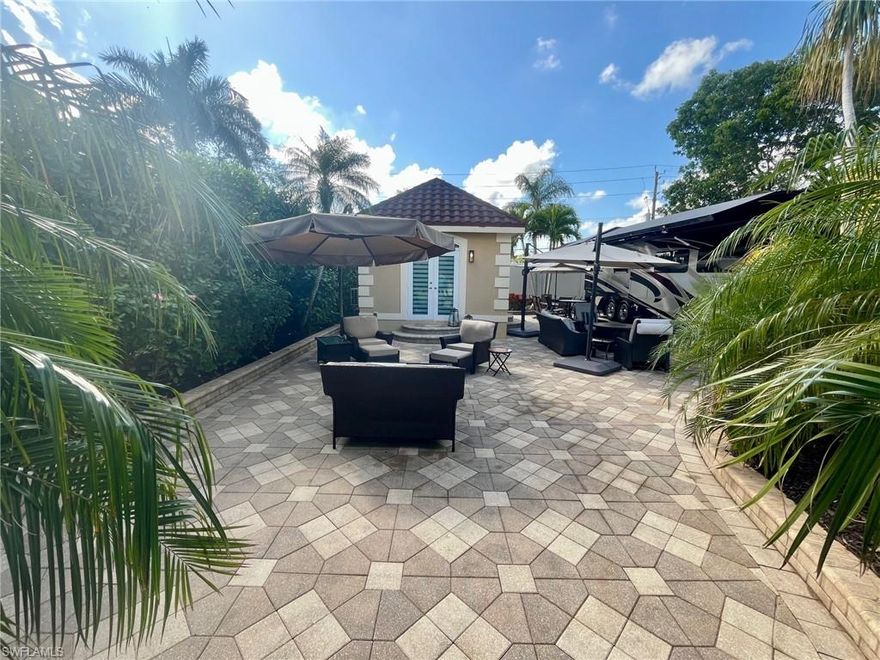 Site Details: 
Class A motorcoach, off-lake site with northern exposure located in Pelican Lake Motorcoach Resort in Naples, FL. This property is upgraded with pattern pavers with a large expanded patio area including raised wall edging finishing off the sleek look.  The patio area is a serene oasis for relaxation with lush tropical landscaping surrounding the pad creating privacy and beauty. The coachhouse built on this property opens up to the patio with double French doors.  This site is move-in ready now and newly approved screen room would be a great addition as well.  
Coach house Details: Custom built 308 square foot coachhouse in 2015 is finished with a full bathroom with stand alone shower, kitchen with wall oven and microwave, dishwasher, under counter wine fridge, small refrigerator, and stainless farmhouse kitchen sink, and large open living area with built in cabinetry. Furniture not included.