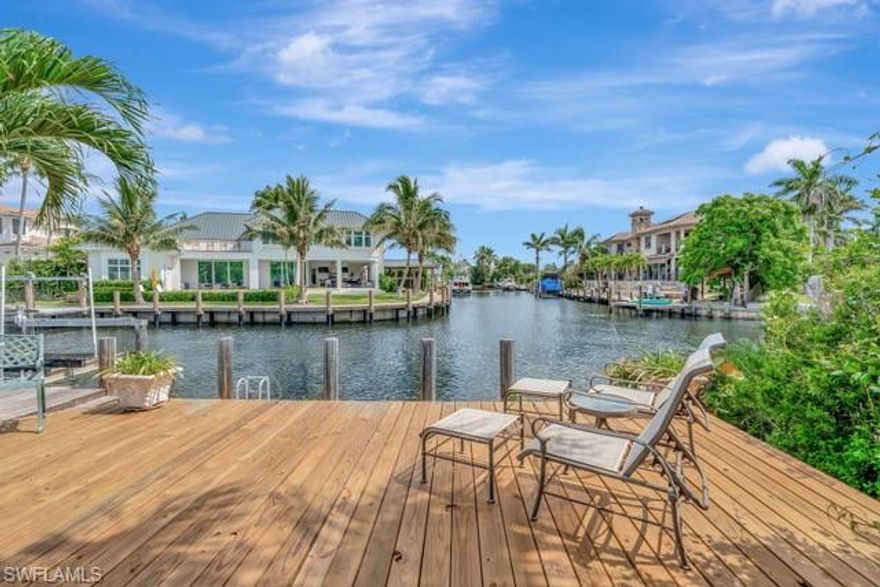 Being Sold at LOT VAlUE, this prime location is on the "T"of a canal and a 7 iron to Naples Bay! - Discover one of Naples’ finest waterfront opportunities located in the prestigious community of Royal Harbor. This lot offers 80 feet of water frontage, with direct Gulf access and no bridges—ideal for boating enthusiasts and luxury home builders alike. A 12,000 lb boat lift is already in place, making this an immediate option for enjoying Naples Bay and the Gulf of Mexico. Whether you're ready to move in or want to build your dream estate, this property delivers flexibility and value. Single level living in this 2,450 sq/ft, 3 Bedroom 3 Bathroom residence is easy and has a spacious den for remote office or to be converted into any number of uses. The house is perfect for seasonal use, rental income, or a comfortable base while you design your custom build. Ideally located less than 200 yards from the bay the dock is at the "T" of another canal offering long water views in three directions from the pool and outdoor area. Situated just minutes from 5th Avenue, fine dining, beaches, and world-class marinas, this location offers the best of Naples living with no HOA restrictions. Royal Harbor makes up the Eastern shore of Naples Bay and is one of the friendliest and most convenient water front communities in South West Florida.