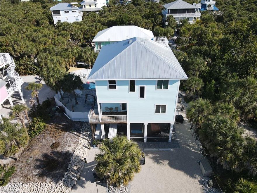 Welcome to 4500 Butterfly Shell Dr — Upper Captiva Island.  This is your island retreat, built in 2022.  Accessible only by boat, ferry, or private aircraft.  Upper Captiva is a hidden gem where pristine beaches, unspoiled nature, and ultimate privacy define the lifestyle. This 3BR 4 BA with a den. Home was constructed on pilings with a metal roof, hardie board siding and impact-resistant windows and doors. Which will provide years of maintenance free enjoyment.  The inside: volume ceilings, with a floor plan known as 'the upside-down house,' which allows the bedrooms to be positioned on the first floor therefore cooler in the evening and the living area, kitchen and balcony on the 2nd floor which gives the advantage of tropical breeze and views. Impressive 10 ft ceilings on the first level. 2nd level sliding doors to the balcony are an amazing 8ft high and allows for a great view. Step up to the crow's nest and enjoy beautiful views of the Gulf and the surrounding island.  Each of the three spacious bedrooms features its own private en-suite bath, offering comfort and privacy.  Outdoors, a heated saltwater pool and spa invite relaxation.  This home was designed for relaxing or entertaining with an expansive patio and screening on the ground level.  The pool deck is finished with elegant pavers.  Located just a short walk to the white sandy beaches.  Great entertainment area with Pool Table and shuffleboard.  Luxurious sitting area with hammocks awaiting you. This home offers both convenience and tranquility.  It provides some of Florida’s most spectacular sunsets.  For investors, this property could potentially be a great rental property.