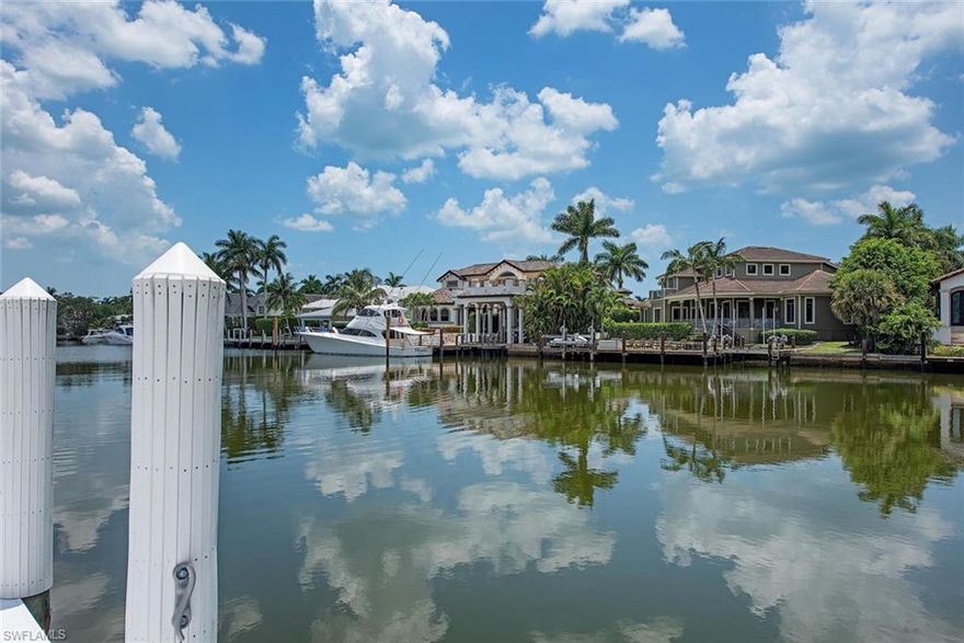 H.16476 - Beautiful wide water, western views overlooking Flamingo Cove yacht basin, this 100’ x 190’ homesite is suited for a future dream home w/dockage for a luxury boat. Direct Gulf access w/Gordon Pass just minutes away! Truly an idyllic, tropical setting with quiet waters and a charming, older home surrounded by palms on a cul-de-sac street. Aqualane Shores is one of the finest neighborhoods in Naples w/nearby shops/eateries/galleries & pubs. The laid-back ambiance of this home is sure to please & relax you. Catch a breathtaking sunset at the beach or ride your bike to the pier. Hop in your boat for a day of fishing or out to the 10,000 Islands. Naples is “paradise found” & this property is awaiting your vision for your next chapter. When thinking real estate, always remember...location, location, location!