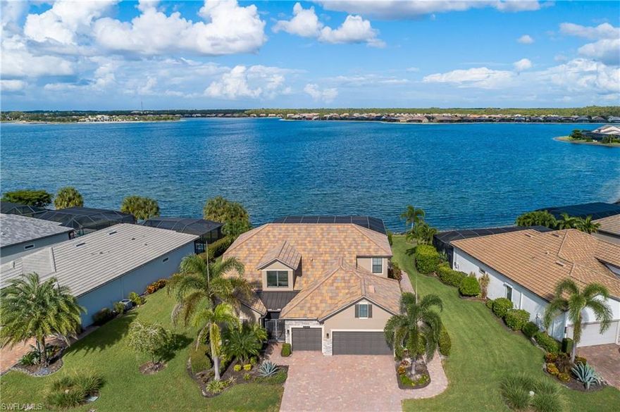 Fabulous setting on the 240-Acre BIG LAKE on an oversized estate lot. Live like you’re on vacation- permantely here at the ‘resort style community CORKSCREW SHORES’! The outdoor oasis is AMAZING Step inside this Stonewater floor plan by Pulte Homes. Close to 4,000 sq ft under air with a total of 4710 sq ft entertaining space. 4 bedrooms, Office & 4 ½ baths. The owner’s suite overlooks the lake and includes a spa style en-suite bath with dual vanities, walk-in shower, and a generous walk-in closet. Each additional bedroom has its own adjacent bathroom, offering comfort and privacy for family or guests. Upstairs, a spacious loft adds even more flexibility with a wet bar, cabinetry, wine chiller, and an extra walk-in closet—perfect as a media room, guest suite, or entertainment space. Enjoy an active, outdoor lifestyle with a custom-designed lanai featuring two access points, travertine stone tile, a stunning HEATED CUSTOM POOL & SPA with sunshelves, an outdoor shower, POOL BATH all with picture window view of the lake. Feel hurricane safe with IMPACT windows/sliders plus a whole-house generator. 3 car garage with 4ft extension. 2 new HVAC systems & water filtration system. No club fees or CDD tax. Not in a flood zone. Amenity island overlooking the 240-acre lake features a zero edge pool with fountains, spa, indoor/outdoor restaurant and bar overlooking the firepits. Enjoy kayak and canoe launch, fishing pier, non-gas boating, 24-hour state of the art fitness center, movement studio, basketball, tennis, bocce, ping pong, and pickleball courts, playground, picnic area, and scenic nature trails. Conveniently close to FGCU, RSW Airport, Hertz Arena, open air shopping, public golf courses and dining. Estero (SW) Florida is vibrant & so close to everything.