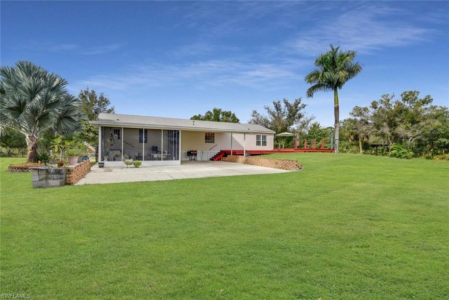 Welcome to the peace and serenity of country living at its best! A unique property, located on 5 acres, fully fenced, this property is adjacent to Corkscrew Sanctuary. 3 bedroom 2 bathroom manufactured home that has been meticulously maintained. Split plan with large eat in kitchen with plenty of storage. Enjoy relaxing on the oversized deck surrounding the 25’ above ground pool.  Park your car and toys in the detached 24 x 24 two car garage with insulated walls and air conditioning or in the additional 24 x 20 carport attached to the home. Enjoy the tranquil setting and the wildlife from your front porch or screened in patio. Take a trail ride through the cleared paths to the stocked fish pond. This property is beautifully landscaped with Bismark, Royal, Robellini, and Foxtail Palms. Location is great with an easy drive to the Publix shopping plaza, Collier County Fairgrounds, the new Regional Park and much more.