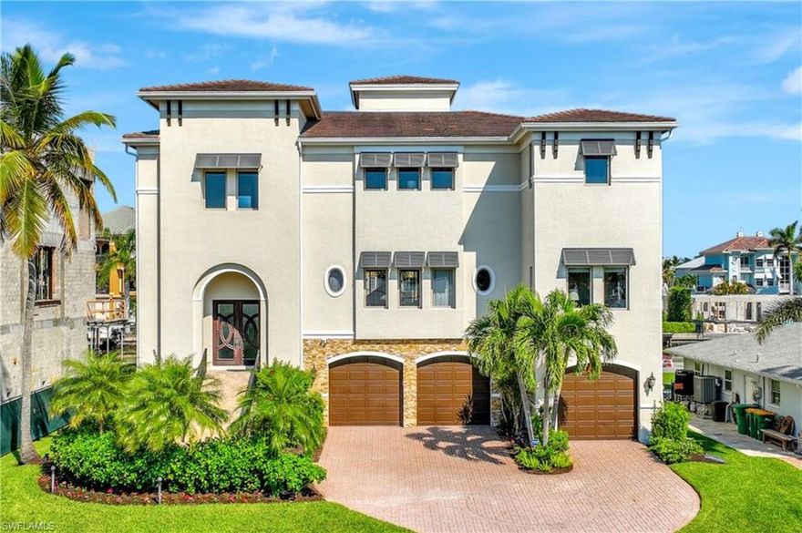 Indulge in the epitome of Naples living with this exquisite Conners waterfront estate. This immaculately upgraded residence is offered turnkey with luxurious designer furnishings. Boating enthusiasts will love the quick Gulf access and newly constructed sea wall/boat dock that will accommodate a large boat w/a 24,000 lb lift. Upon entry, you can feel the grandeur of this home w/soaring 30-ft ceilings & a vast open floor plan. The primary level is anchored by the custom gourmet kitchen, showcased with a double island & sleek quartz waterfall countertops & also includes living and family rooms, formal dining, den, and an en-suite guest bedroom. The upstairs level includes four professionally adorned bedrooms, highlighted by a primary suite that epitomizes luxury with water views, custom his/her closets, and a stunning oversized bathroom. The lower level provides a 3 car garage, additional storage, and bonus space that is perfect for entertaining with a game room, living room, and oversized bar that flow seamlessly to the outdoor living area. Conners at Vanderbilt Beach stands as the pinnacle of waterfront living in North Naples, with close proximity to the Beach and nearby amenities.