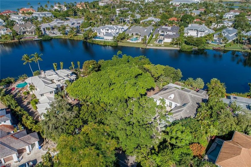Beautiful lakefront lot opportunity in Old Naples. Situated on Alligator Lake, this partially gated lot is the perfect location for secluded living and just steps from the beach. Enjoy private alley access right off 3rd St N.