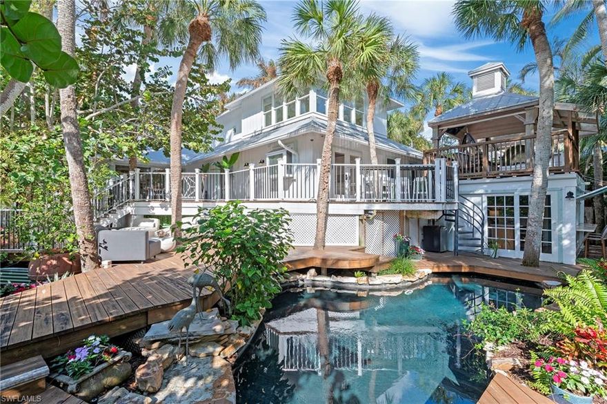 PRICED AT LAND VALUE! — (Optional 50’ boat slip at the Cove Inn available for purchase with the property.) Opportunity knocks for a chance to own the ultimate beach cottage in one of Naples’ most coveted locations, just steps from the iconic Naples Pier and the white sugar-sand beaches of the Gulf. Privately tucked within lush tropical landscaping, this one-of-a-kind “Swiss-Family Robinson Treehouse” blends artistic charm with modern comforts, creating a secluded retreat in the heart of Olde Naples. Just a short stroll from the boutiques, fine dining, farmers markets, local parades and vibrant coastal lifestyle of 3rd Street South, the setting simply cannot be replicated. Designed for both relaxation and entertaining, the property showcases an incredible collection of unique indoor and outdoor spaces, including a heated swimming pool, private courtyard oasis, detached bar house with full kitchen, tranquil koi pond, infrared sauna, outdoor shower, and a raised covered “widow’s watch” seating area perfect for enjoying Naples sunsets, firework shows and coastal breezes. Additional highlights include a durable metal roof, back-alley access, oversized driveway for 5+ vehicles, and exceptional privacy throughout the property. Situated on a 77’ x 151’ lot, the possibilities are endless. Whether you envision renovating and enjoying the existing residence, creating a luxury custom estate, or developing a high-end investment property, this homesite offers extraordinary potential in a premier beach-block location right in the action of downtown Naples. Investors will appreciate the strong vacation rental and spec-home opportunities, while end users can create the ultimate private beach retreat just a few steps from the Gulf of Mexico. Adding to the long-term appeal, the newly reimagined Naples Pier is nearing completion, further enhancing the value and desirability of this exceptional location. A rare offering with unmatched character, location, and future potential — this is Olde Naples living at its finest. High and dry with no flooding waters entering the main residence.