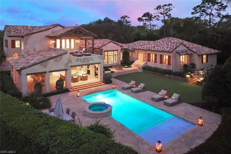 This authentic custom home, hand-crafted by BCB Homes in 2009, is on an extremely private .74-acre homesite within the prestigious Mediterra community. Offering over 6,600 square feet of luxurious living space, the residence features four bedrooms, four full baths, and one-half bath designed for elegance and comfort. The open-concept floor plan is ideal for entertaining family and friends, with a chef’s kitchen boasting top-of-the-line Viking and Sub-Zero appliances, a spacious center island, a well-appointed butler’s pantry ideal for catering and abundant custom cabinetry. The family room serves as the heart of the home and flows seamlessly into an impressive library adorned with vaulted wood-beam ceilings and a stone gas fireplace. The private owner’s suite is a serene retreat, highlighted by hand-scraped wood floors, an adjacent wood-paneled study, a white marble bath and dual custom closets. Outdoor living is equally impressive, featuring a large, covered lanai with a dining area, comfortable sitting space and a fully equipped outdoor kitchen. The outdoor oasis continues with a heated pool, raised spa and gas fire pit, ideal for year-round enjoyment. Additional features include a Lutron lighting system, a climate-controlled three-car garage, Andersen impact windows and doors, and a custom temperature-controlled wine cellar. Residents of Mediterra enjoy an unmatched lifestyle with access to two 18-hole Tom Fazio–designed golf courses, a full-service wellness and fitness center, and a newly refurbished Beach Club offering an elevated pool and Gulf-front dining on the white sands of Hickory Island. A world of luxury, privacy and craftsmanship awaits within this exquisite Mediterra estate.