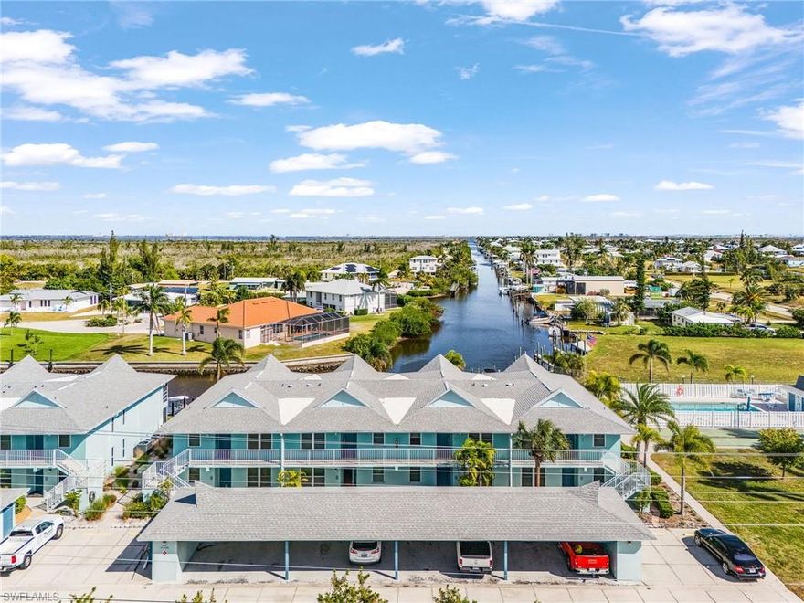 Discover coastal living at its finest in this beautifully renovated 2-bedroom, 2-bath waterfront condo located in the highly desirable Fisherman’s Wharf Community of St. James City. Enjoy direct Gulf access with no bridges making your quick trip to open water effortless and convenient. The property includes a private boat slip, and owners also have access to the community boat storage yard, perfect for boating enthusiasts.

Step inside to find a fully updated interior featuring a modern kitchen with stainless steel appliances, quartz countertops, and crisp white cabinetry. Both bathrooms showcase contemporary vanities and sleek tile backsplashes in the showers. The main living area boasts luxury vinyl plank flooring, while the bedrooms offer brand-new, never-used carpet for comfort.

Relax and take in serene waterfront sunrises from your screened-in lanai, the perfect spot to enjoy your morning coffee or unwind in the evening. The condo also includes a carport and additional storage closet for added convenience.

Located just a short, safe walk from local favorites like Phuzzy’s Boat Shack, Low Key Tiki, and the Fresh Seafood Market, you’ll love the vibrant island lifestyle. Spend your days exploring nearby destinations such as Sanibel, Captiva, Cayo Costa, Fort Myers, Cape Coral, and more—all just a short boat ride away. With world-class fishing in Pine Island Sound and Boca Grande, friendly neighbors, and a quiet, welcoming community, this property offers the perfect blend of luxury, comfort, and adventure.