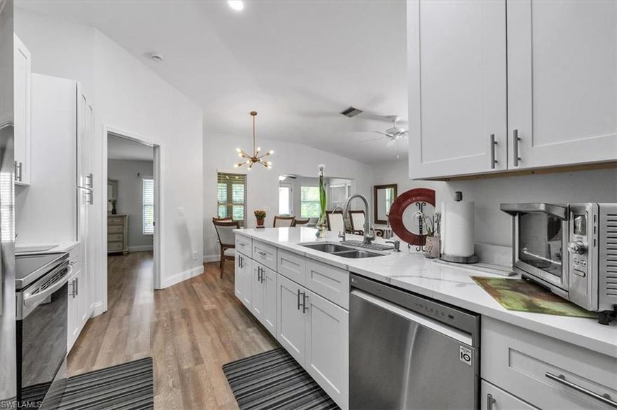 Welcome to this beautifully renovated 2 bedroom, 2 bathroom home with a versatile den in the heart of Lehigh Acres. Spanning 1,261 square feet, this home has been meticulously updated with modern finishes and attention to detail.

Step inside to discover brand new luxury vinyl flooring that flows seamlessly throughout the open concept living areas. The updated kitchen boasts stainless steel appliances, brand new cabinetry, and elegant quartz countertops, perfect for both daily living and entertaining.

The home features updated lighting throughout, creating a warm and inviting ambiance. An enclosed lanai adds extra living space, ideal for relaxing or entertaining. Plus, the property includes a two car garage for convenience and storage.

Partially furnished and move in ready, this home is perfect for those looking for a blend of comfort and style in a vibrant community. Gated community with low HOA dues and just steps away to the clubhouse/pool. Don’t miss out on this gem!