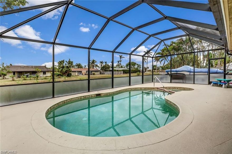 Amazing location. Super low fees only $60 annually! Totally remodeled 3 Bedroom plus Den, 2 Bath pool home. Kitchen is huge with updated cabinetry, stainless steel appliances, granite countertops. Newer roof and A/C system !! Tall baseboards, designer lighting, tile and wood flooring. Hurricane shutters for the windows and fantastic roll shutters for the back sliding doors. Home feels very spacious and spread out. Private and large home on a canal. Pool is freeform with a very large screened lanai.