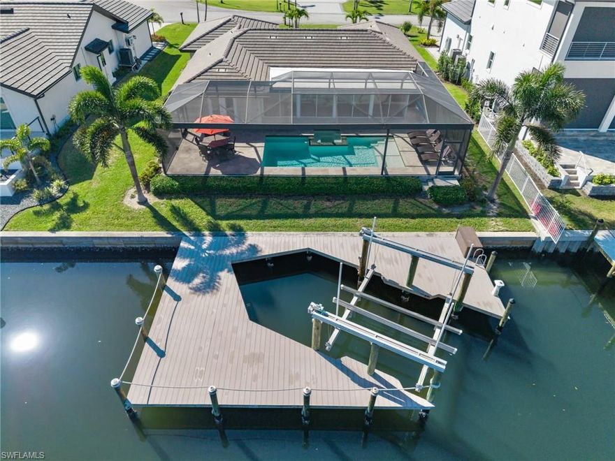 Waterfront living at its finest in the deed-restricted community of Palm Acres, ideally located near Sanibel Island. This Gulf access property offers 80 feet of frontage on a 120ft wide saltwater canal with deep water capable of accommodating large boats and provides quick access to the Caloosahatchee River, Shell Creek, and the Gulf of America—making it a true boater’s paradise. This well-maintained residence features 1,634 square feet of air-conditioned living space with 2 bedrooms, 2 bathrooms, a spacious great room, and a 2-car garage, plus an additional 400-square-foot Florida room enclosed by glass sliding doors—perfect for enjoying peaceful waterfront views year-round. Outdoor living is exceptional, highlighted by a $130,000 custom pool and spa built in 2020, complete with a travertine pool deck, picture window pool cage, electric pool heater, and convenient Aqualink 2.0 system. Boating enthusiasts will appreciate the $70,000 wrap-around dock constructed in 2021, featuring durable PVC decking, 50amp service, and a 24,000-pound heavy-duty boat lift supported by six pilings. Previous owner had a 42ft Nor-Tech Hi-Performance boat on this lift! Interior features include a well-appointed kitchen with granite countertops, stainless steel appliances, pendant lighting above an oversized island, dining area, and a built-in desk with custom cabinetry. Flooring throughout the home includes tile, carpet, and luxury vinyl plank. The primary suite offers dual sinks, an upgraded tile walk-in shower, and a large walk-in closet. The guest suite bathroom has been beautifully remodeled. Additional highlights include a new tile roof installed in 2021, upgraded tropical landscaping with palm trees and granite chip plant beds, irrigation supplied by a private well, and the convenience of being sold fully furnished, including lanai and pool area furnishings—making this property truly move-in or rental ready.
This exceptional Gulf access waterfront home delivers the ideal Southwest Florida boating lifestyle in a highly desirable location near world-class beaches, dining, and recreation. Watch the video! Look closely at the photos! And, call now!