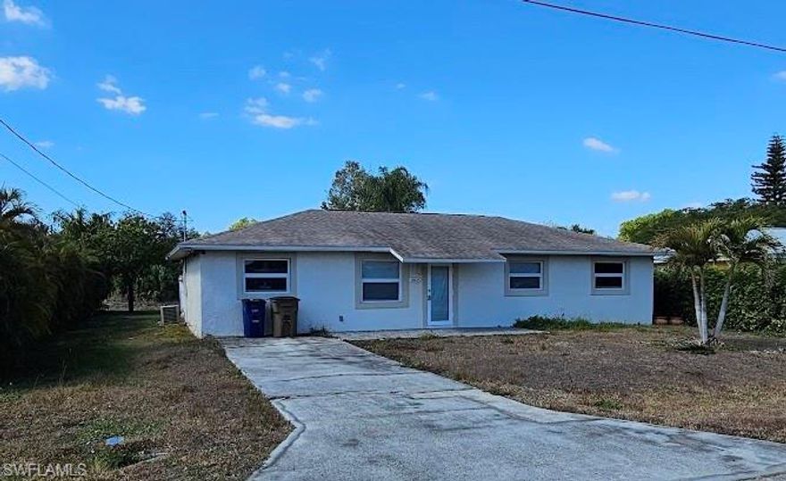 REHAB OPPORTUNITY – INVESTOR SPECIAL WITH PERMITS PULLED! This 3-bedroom, 1-bath home in Fort Myers was in the process of being converted into a 4-bedroom, 2-bath residence prior to the hurricanes, with permits already pulled for the planned modifications. The buyer will be responsible for reactivating the permits to complete the work. The property presents a prime opportunity for investors, contractors, or buyers looking to customize and add value. The home features tile flooring throughout and a partially completed primary bathroom. The kitchen requires installation, and drywall replacement is needed along the interior of the exterior-walls. The western side of the roof sustained damage due to wind during the storms and will need repair or replacement. Importantly, the home did not experience flooding. The a/c system needs to be replaced.  The future fourth bedroom and second bathroom—located in the former one-car garage—are currently at the stud stage and ready for completion. The laundry room also remains unfinished, offering flexibility in layout and design. Outside, a large concrete patio offers ample potential to expand the home’s footprint or create an outdoor living space. The spacious backyard offers room for a pool, while a drainage canal behind the property adds privacy with no rear neighbors and provides drainage. With strong rental potential and significant upside after completion, this property is an excellent opportunity to renovate, customize, and capitalize in a growing Fort Myers location.