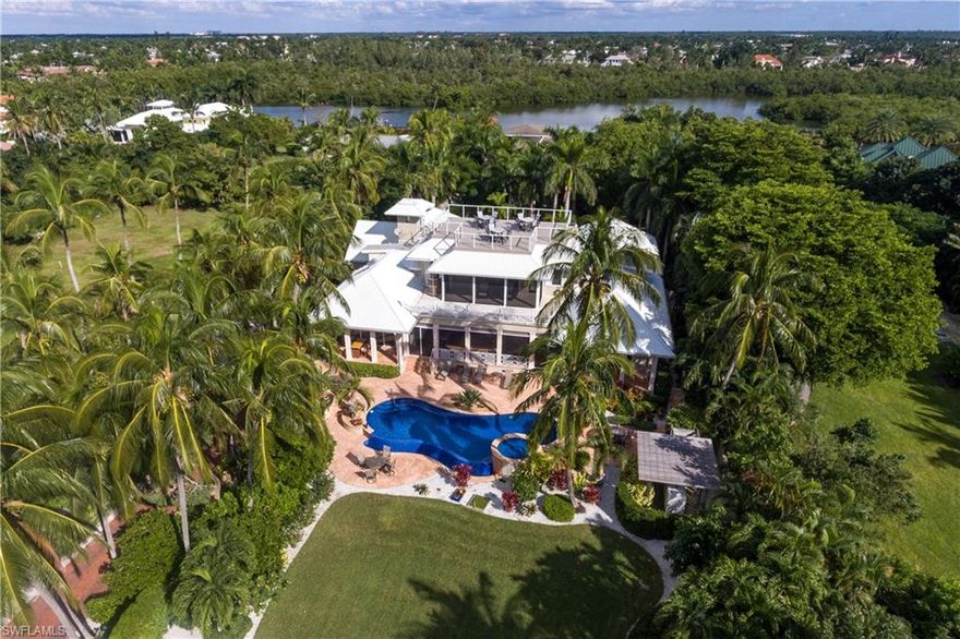 A Caribbean styled family home directly across from a private deeded beach access offering views of the Gulf of Mexico fringed by swaying palms. This refreshing luxury home was designed by Kasimir Korybut and built to the exacting standards of A. Vernon Allen Builders. Updated in 2014 by Paragon with a clean sophistication and a distinguished original style that sprawls over 7,855 square feet of living space featuring 4 bedroom suites, study, formal living room, dining room, home theatre and a gourmet styled kitchen. Additional features include wood and marble floors, fireplace, elevator, 8-car air conditioned garage, 80 kw whole house generator, and an abundance of storage space. The master suite, complete with his and hers baths, includes a spacious covered terrace with outstanding Gulf views. Perfect for al fresco dining, there is large covered porch the overlooks the vanishing edge pool and spa finished with mosaic glass tile and marble decking. This beautiful property has Port Royal Associate membership eligibility.