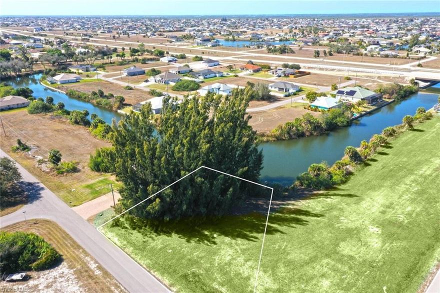 Enjoy beautiful intersecting canal views and a long, peaceful water vista from this prime freshwater homesite in NW Cape Coral. With water right in your backyard, this property offers the perfect setting to build your custom dream home and enjoy the best of Southwest Florida living. Relax in the evenings with a western rear exposure—perfect for soaking in spectacular sunset views over the water. Surrounded by nature and quiet residential streets, this location offers both tranquility and outdoor recreation. Just minutes away, the Burnt Store Boat Ramp provides easy access for launching your boat and exploring the area’s waterways—making it simple to enjoy fishing, kayaking, and days out on the water. Conveniently located near Coral Oaks Golf Course, you’ll also enjoy quick access to golf, parks, and growing shopping and dining options while still being tucked away in a peaceful setting. Build the home you’ve always wanted and embrace waterfront living at its best in Cape Coral.