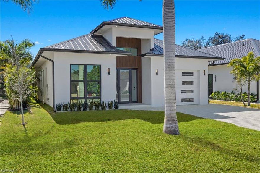 Welcome to your dream home in Naples Park! This Newly Constructed home features a modern design & unique architectural interest, just blocks away from the Gulf. The home features an open floor plan with high ceilings. Large panoramic windows fill the space with natural light. The kitchen is a chef's delight, featuring a modern design with Travertine countertops and backsplash. This beautifully designed home features an elegant master bedroom with panoramic windows and en-suite bathroom with custom floor-to-ceiling tile. Plus three additional bedrooms, each having private en-suite bathrooms, and a guest half bath also. Step outside to your private escape, lanai with a heated pool/spa, surrounded by limestone pavers, a fully fenced yard, full irrigated lawn. Lanai also features a covered outdoor kitchen and grill area, perfect for entertaining. This property is a masterpiece of design offering stunning tropical landscape views. This home is close to Naples beaches and shopping areas, offering the perfect blend of style and comfort. Located in the highly-desired Naples Park area, this community has no HOA restrictions. Don't miss the opportunity to make this luxurious retreat your own!