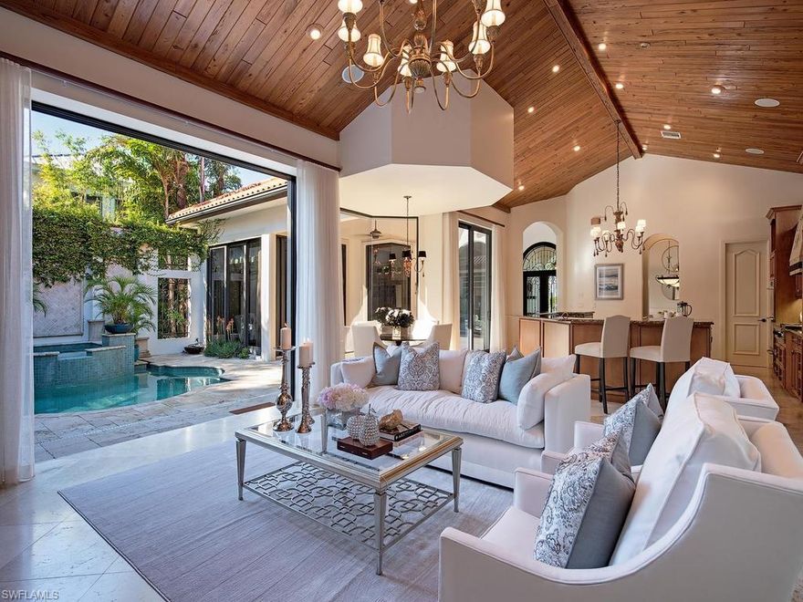 H.14286  Stunning custom built courtyard home. Only one block to the world renowned elegant Third Street South for shopping and fine dining. The ideal Naples retreat with privacy in mind. Spacious owner's suite has a large sitting area, two walk-in closets, large "Jacuzzi" soaking tub, walk in shower and two vanities. Easy access to the pool and spa, and outdoor entertaining areas. The two guest suites, one a cabana off the pool, were designed for your guests to enjoy their privacy in comfort and style. Walk-in wine room off the formal dining room, a butlers pantry between the true chef's kitchen that features gas cook top, two sinks, large island with ice maker, and a walk-in pantry. Vaulted ceiling in the Great room features tongue and groove "pecky" cypress ceiling, gas fireplace and large windows to let in light and air. Private den/study at the front of the home has beautiful builtins. Large bonus room upstairs. Two covered outdoor living areas, one with a fireplace and kitchen.