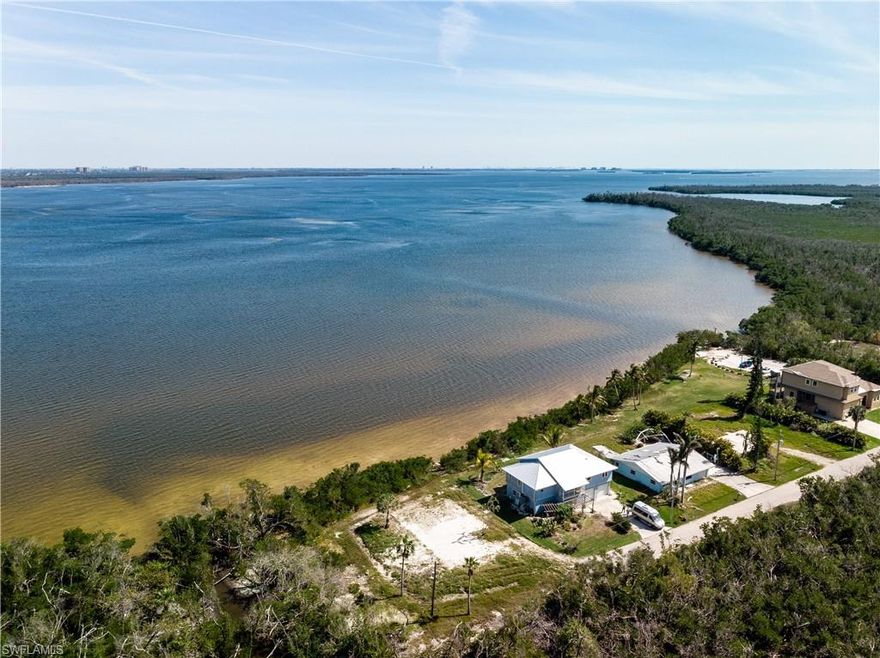 A little over a quarter acre waterfront lot for sale in St. James City! Home was demolished after suffering hurricane damage which will save buyer on impact fees to build new. An elevated home will afford spectacular views of Matlacha Pass. Although the lot is not suited for a private dock, there is access to the water via the Lee County public park to the south of the lot where small vessels such as kayaks, paddleboards or skiffs can be launched. The county owns the waterfront strip, the water can be accessed through the mangroves. Bring your plans and build your dream home!