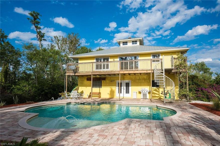 Built on 2.81 acres in 2001 by Kenmark, this home's features begin at the entrance of the paved driveway where you are met with a electric security gate and beautiful landscaping. The home has a Key West style with a metal roof, front and back decks, plantation shutters, and an in-ground pool with water feature. Master suite with full bath, two bedrooms and second bathroom are located on second level. On the ground level you will find a large bedroom, full bath, and additional living area, which all could be used as an in-law suite.  The home has a two car garage with ample storage, which could also be turned into additional housing space. Lots of options with this home.