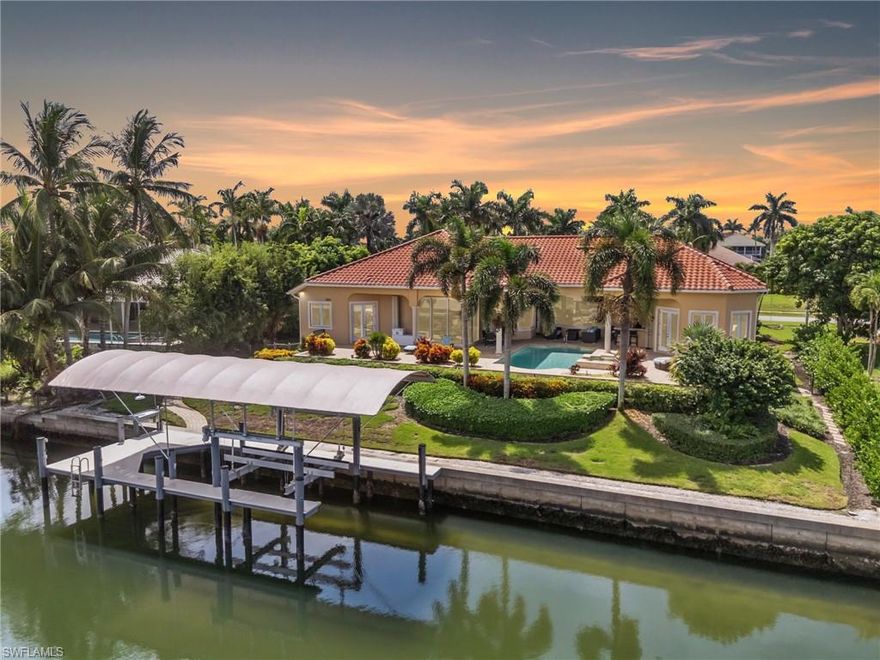 Significant price modification!
Positioned on one of the most prestigious streets in the Estates of Marco Island, this custom Divco residence now reflects a rare opportunity for buyers seeking both luxury and long-term value. The prestige of Caxambas Ct, paired with 13.4 feet of elevation, a whole-house generator, impact windows, and a 2018 roof, offers unmatched peace of mind in a property that’s as secure as it is spectacular.

You can change a house, but you can’t change location—and this one delivers with direct Gulf access and a half-acre setting along a wide waterway. A composite dock with new boat cover, fishing station, and 16,000-pound lift gives your vessel the home it deserves, with quick passage to the Ten Thousand Islands and beyond.

Inside, refined coastal living unfolds through soaring glass pocket doors, seamless windows, and an open design that blends formal living and dining with an expansive family room and chef’s kitchen. Entertaining is effortless with custom cabinetry, a butler’s pantry, wet bar, and morning room, while the grand lanai extends the experience outdoors with a full kitchen, bar, pool, and spa framed by lush landscaping and shimmering water views.

The primary suite provides a private retreat with dual walk-in closets, a soaking tub, walk-in shower, and dual vanities. Three guest suites, a dedicated office with extra storage, and a separate pool bath ensure comfort and privacy for family and friends.

Practicality meets luxury at every turn: a 125-foot elevated seawall, 500-gallon propane tank, impact protection, mosquito-misting system, and a three-car garage with new flooring. Thoughtful updates — including a new washer and dryer — further elevate the home’s readiness.

This is more than a home — it’s a rare chance to embrace the Estates lifestyle, where coastal elegance meets strength, security, and an exceptional new value.