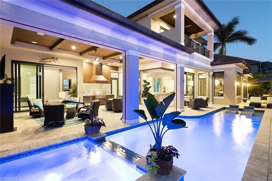 Featured in Gulfshore Life Home magazine, this home spared no expense! This custom-built & designed home was professionally decorated & designed by Leili Design Studios. Foyer has 25' ceiling & custom chandelier. Great room has disappearing edge custom sliding glass doors & intersecting waterway views! Open concept home has wood-look porcelain tile floors. 25' ceilings, custom 3-dimensional media wall, wet bar & wine cooler. Kitchen has Wolf appliances, gas stove & quartzite counters. Master suite opens to outdoor lanai & fireplace, custom lighting & 3-dimensional walnut media wall. Master bath has huge shower, chandelier, dual walnut vanities with leathered marble counters. Upper level has 2 bedroom suites, media room, wet bar, water views! Outdoor living area covers rear of home. Outdoor fireplace, built in grill, quartzite counters, full length saltwater pool & spa. In wall screens, hurricane shutters & disappearing edge doors bring the outdoors in! The huge dock has 2 boat lifts & Jet Ski lifts, each decked over to create a seamless drop-down lift made of composite graphite. 3-car garage with custom epoxy garage floor, suspended storage racks & bike racks! Being sold furnished!