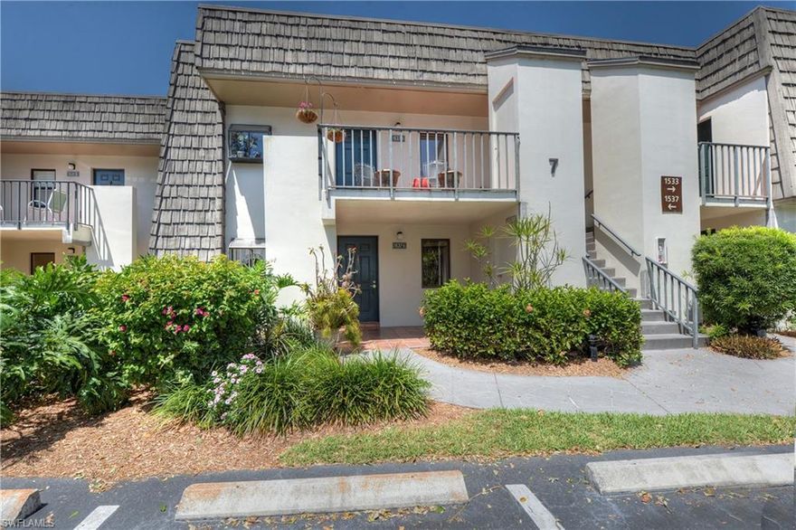 Enjoy the highly sought after Oyster Catcher Point neighborhood offering beautiful mature oaks, palms and a private pool and spa. Private cul-de-sac, ideally situated overlooking a tranquil view of lush landscaping and lake, this West facing first-floor two-bedroom two-bath condo features tile throughout great room and guest bedroom, carpet in the master bedroom, brand new paint throughout, upgraded master bathroom and walk-in closet off master bedroom. Guest bedroom has private en-suite guest bathroom.  The AC system was replaced in 2013 and has maintenance contract for every 6 months service. Naples Bath and Tennis is a gated community and located on 160 acres and includes lovely exercise paths. Optional membership is available for the tennis player with 37 Har-Tru tennis courts, as well as a clubhouse, junior Olympic sized pool, fitness and dining. Naples Bath and Tennis is home to the Sanchez-Casal Tennis Academy.