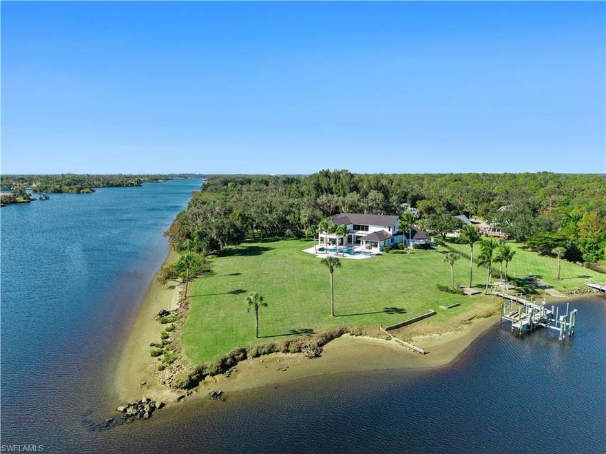 A rare Waterfront estate offering privacy, scale, and true deep-water boating. This property is truly special! As you approach the home, an expansive grand driveway entrance leads to a private estate located at the end of a quiet street. Situated on a premier corner lot just outside the city, this property offers pure peacefulness and a true Old Florida lifestyle rarely found in today’s market. The estate spans approximately 1.5+ deeded acres (2.5+ usable) with an impressive 750+ feet of river frontage, delivering breathtaking 180-degree river views and a sense of seclusion throughout. Mature oak trees, lush landscaping, a newer boat dock with two lifts, and direct Gulf Yacht access complete this exceptional waterfront setting. Outdoor living is centered around a resort-style pool with a center spa and sun shelf, paired with a fully equipped professional outdoor kitchen, ideal for relaxing or entertaining along the river. Recessed exterior lighting surrounds the home, creating a refined evening ambiance. Inside, the home offers over 6,000 square feet of well-designed living space with 6+ bedrooms. A soaring grand entry immediately draws your eye to the water, with expansive river views, abundant natural light, and high ceilings throughout. Natural oak flooring runs throughout the home and is complemented by custom baseboards.The open floor plan flows into the chef’s kitchen featuring a large island, Wolf appliances, Sub-Zero refrigerator/freezer, wine cooler, butler’s pantry, granite countertops, and floor-to-ceiling custom cabinetry. Zero-corner impact sliders seamlessly connect the interior to the outdoor living areas, making this home ideal for entertaining. The primary suite features a spacious custom closet and a stunning master bathroom with a walk-in shower, stand-alone soaking tub, and dual vanities. Additional features include a whole-home reverse osmosis system, flood barrier system for peace of mind, oversized garages large enough to park a large boat, RV and or your car collection, and extra large storage space in a dedicated room above the garage. This waterfront location offers large yacht boating access, east or west. Be on the east coast in hours via the lock system out to the Atlantic Ocean or head to the Keys out the river and to the Gulf waters. A truly special riverfront property offering privacy, quality, and unmatched boating access in Lee County.