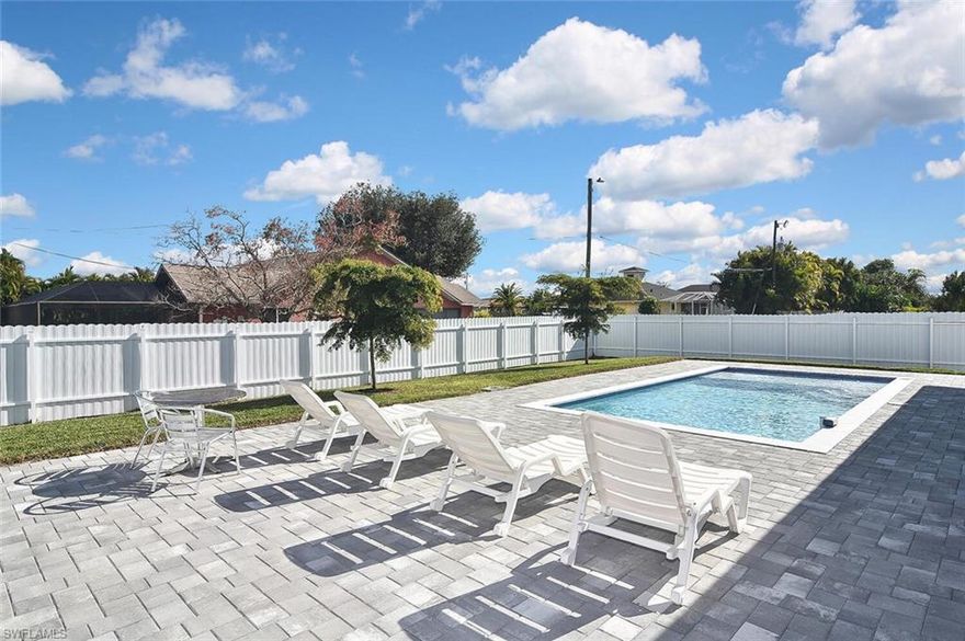 Located in a non-flood zone with no flood insurance required and all assessments paid, this 3-bedroom, 2-bathroom home with a den, luxury pool home built in 2024, offers peace of mind along with exceptional craftsmanship, thoughtful design, and premium upgrades throughout. Truly unlike anything else in the area, the home delivers both elegance and functionality at every turn.

From the moment you step inside, you’ll notice the seamless 24x48 porcelain tile flooring that flows throughout the home, paired with soaring ceilings—including an 11’4” main living area and a 12’4” tray ceiling—creating a bright, open, and sophisticated atmosphere.

The kitchen is the heart of the home and was designed for both everyday living and entertaining. It features white shaker cabinets, a striking quartz waterfall island, stainless steel smart appliances, a slide-in range, an elegant tile backsplash, and a pantry conveniently located off the kitchen. A custom-built entertainment wall adds both style and functionality to the living space.

The private primary suite is a true retreat, offering a spacious bedroom, two expansive walk-in closets, dual vanities, and a beautifully tiled shower with a glass enclosure. The second bathroom features a tiled shower with a glass shower door and includes direct access to the lanai, making it ideal for poolside living.

Step outside to your own backyard oasis, featuring a paver pool area, a pool with a sun shelf, a covered lanai, and a summer outdoor kitchen—perfect for everyday enjoyment. The spacious fenced yard is ideal for gatherings, pets, and outdoor entertaining, and includes rear gutters for pool drainage and additional concrete poured along both sides of the home for erosion control.

Additional features include impact doors and windows, a paver driveway, a double-entry aluminum front door offering durability and a modern aesthetic, an insulated garage door, a smart garage door opener, an epoxy garage floor with speckle, built-in shelving in the garage, a 50-amp generator plug, blinds throughout, ceiling fans in all bedrooms, and automatic sprinkler irrigation.

Located in the heart of central Cape Coral, this home offers a prime and highly desirable location just minutes from shopping, dining, schools, parks, and major roadways. Everything you need is less than five minutes away, making it ideal for families and professionals alike. This central setting perfectly blends comfort, quality, and convenience in one of Cape Coral’s most sought-after areas.

With its open floor plan, designer finishes, pool bath access from the lanai, and countless upgrades, this home feels new and is completely move-in ready—ideal as a primary residence, seasonal retreat, or investment opportunity.

Schedule your private showing today and experience modern Florida living at its finest.