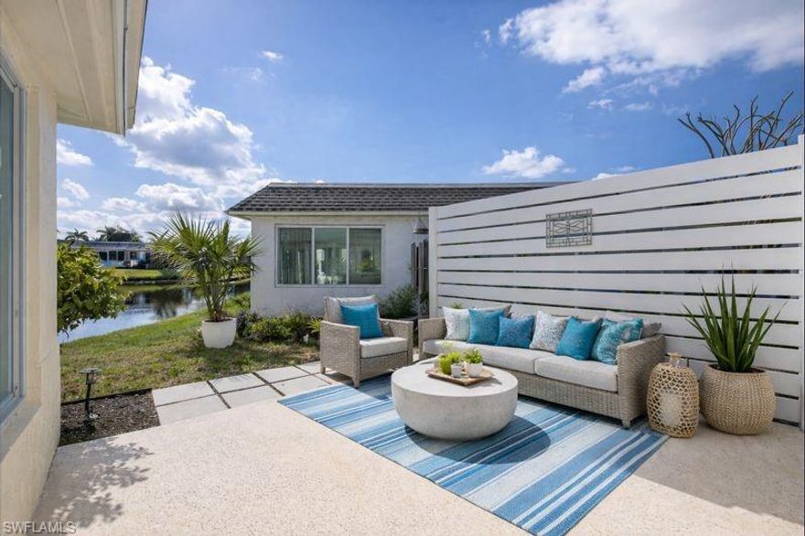 Experience effortless coastal living in this beautifully re-envisioned 2-bedroom, 2-bath villa designed for comfort, style, and ease. The open layout is filled with natural light and enhanced by impact-resistant windows and doors, creating a bright, secure, and welcoming environment throughout.

Step outside to your own peaceful retreat, where a stone-finished patio overlooks serene lake views—an ideal setting for morning coffee, sunset dining, or simply unwinding in the Florida sunshine.

The kitchen has been thoughtfully upgraded for both form and function, featuring premium appliances, sleek finishes, and a layout that makes everyday cooking and entertaining feel seamless.

Additional conveniences include a covered carport and dedicated outdoor storage, perfect for both full-time residents and seasonal owners. The pet-friendly community offers a truly low-maintenance lifestyle, with HOA fees covering water, irrigation, landscaping, and flood and wind insurance.

Ideally located just minutes from the heart of Naples, you’re close to the energy of 5th Avenue South, the creative Bayshore Arts District, Celebration Park, Naples Bay Resort, and Bayfront’s shops and cafés. Pristine Gulf beaches and unforgettable sunsets are only a short drive away.

With the flexibility to rent up to three times per year, this property presents an excellent opportunity as a primary home, winter getaway, or income-producing investment. This is your chance to enjoy relaxed Naples living at an exceptional value—schedule a private showing and see it for yourself.