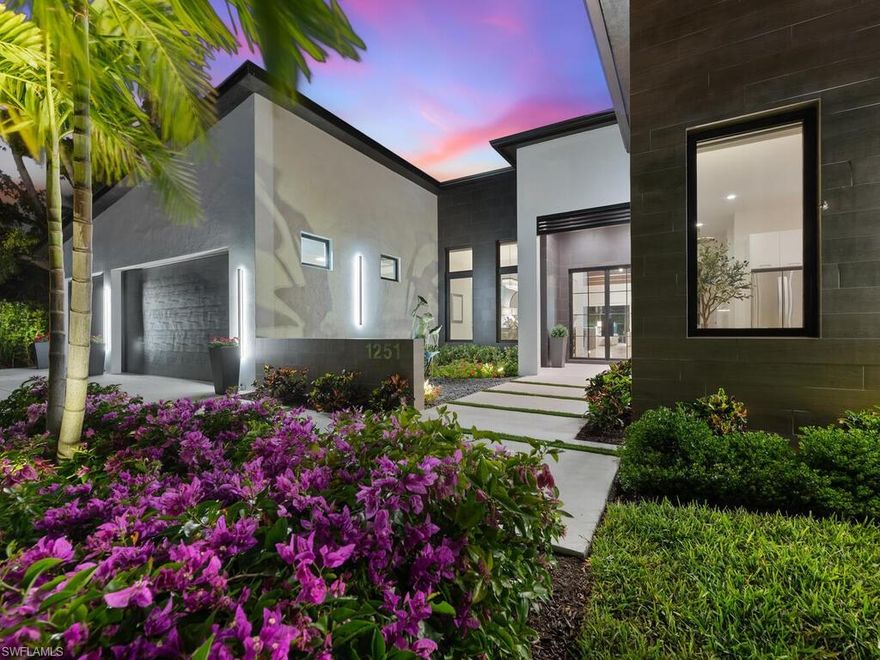 Crafted for Living. Designed for Legacy.
This residence is more than a home—it is a lifestyle statement. A rare single-level estate in the heart of Naples, it balances modern design with luxurious comfort, offering 4,524 sq. ft. under air and 7,312 sq. ft. total, including over 1,400 sq. ft. of lanai and pool deck. Every detail has been curated to elevate daily living and entertaining.

At the center of the home, a spectacular 15-foot kitchen island anchors a chef’s dream culinary suite: 48” Z-Line gas range with dual ovens, dual 36” refrigerator/freezers, convection microwave, dual dishwashers, hidden mixer station, and walk-in butler’s pantry with additional appliances. Glassware rinsers, a freestanding ice maker, and a wine chiller complete the setting for effortless entertaining.

The 14’ x 32’ covered lanai is an outdoor living room with motorized shades, built-in grill with rotisserie, gas fireplace, undercounter refrigerator, and a 75” TV. Just beyond, a spa-style pool with cascading waterfalls, artificial turf, and lush privacy landscaping creates the perfect retreat.

The primary suite is a sanctuary with serene garden views, a spa-caliber wet room with steam shower, chroma-therapy lighting, soaking tub, dual vanities, Toto bidet toilets, and a private outdoor shower. A boutique-style custom closet completes the retreat. Four additional guest suites—each with en-suite baths—are generously scaled for king or dual queen accommodations.

For extended stays or live-in staff, a private guest cabana offers a full kitchen, living area, LG Wash Tower, private entrance, and parking. A flexible design can transform this space into a two-bedroom, two-bath guest wing.

Additional highlights include a 3-car garage with 12’ ceilings (EV-ready), four-zone HVAC, three tankless propane water heaters, 1,000-gallon buried propane tank, Icynene insulation, insulated interior walls, Lutron Caséta lighting, and two LG Wash Towers in the laundry/mudroom.

Located in an A+ rated school district and just minutes from beaches, shopping, and downtown Naples, this home offers rare one-level living, luxury finishes, and extraordinary flexibility—without the $5M+ price tag west of US41.

Live boldly. Entertain effortlessly. Rest luxuriously.
Every finish, every fixture, every space—elevated.