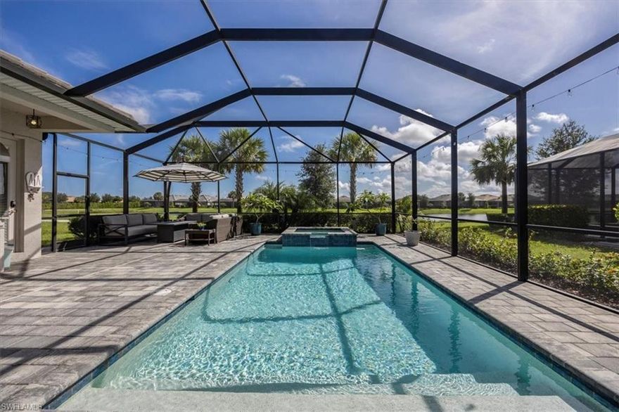 The National Golf & Country Club – Toscana Model by Lennar.  Beautiful 4-bedroom, 3-bath estate home with 2,542 sq. ft. under air, 3-car garage, and a premium cul-de-sac location offering stunning lake and golf course views. Open-concept living with gourmet kitchen featuring quartz countertops, stainless-steel appliances, custom backsplash, and a large 6-person island. Elegant living room includes a custom built-in dry bar/entertainment center with marble counters, custom cabinetry, sconce lighting, and an included big-screen TV. Spacious primary suite with lanai access, custom closet shelving, soaking tub, walk-in shower, dual vanities, and private water closet. Guest wing includes a private suite with its own bath and lanai access. Enjoy resort-style outdoor living on the screened lanai featuring a heated pool with jacuzzi, outdoor kitchen with grill, fridge, and hood vent, and multiple seating areas overlooking the 11th fairway. Additional highlights include crown molding, custom bamboo accent wall, and luxury vinyl plank flooring in the garage with built-in storage. Located in The National Golf & Country Club, a gated community with 24/7 security, this home includes full golf and social memberships with access to a private championship golf course (fully private in 2026), resort pool, fitness center, spa, fine dining, tennis, pickleball, and more — all within the award-winning town of Ave Maria.